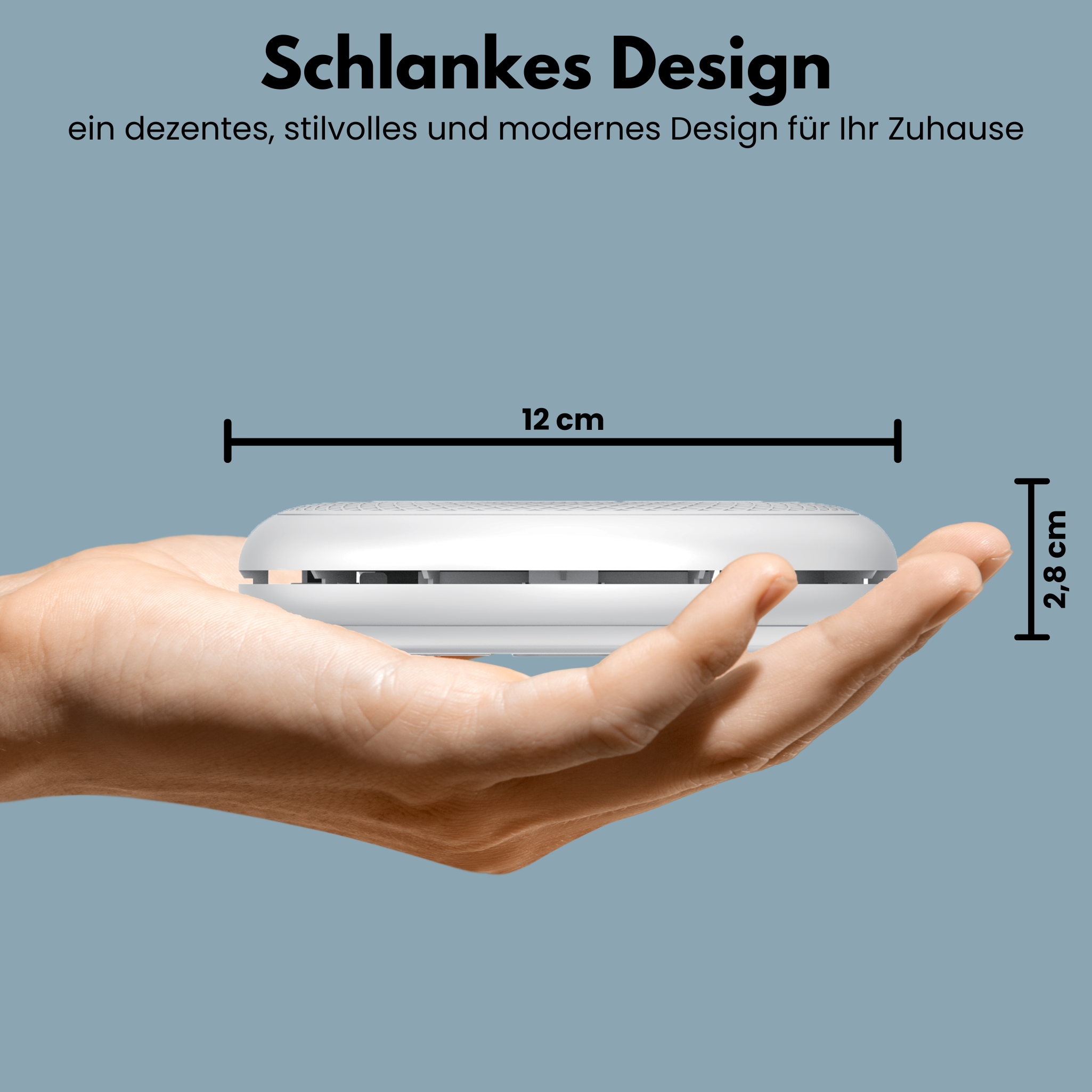 A white, round device, 12 cm wide, 2.8 cm high. Held in a hand on a blue background.