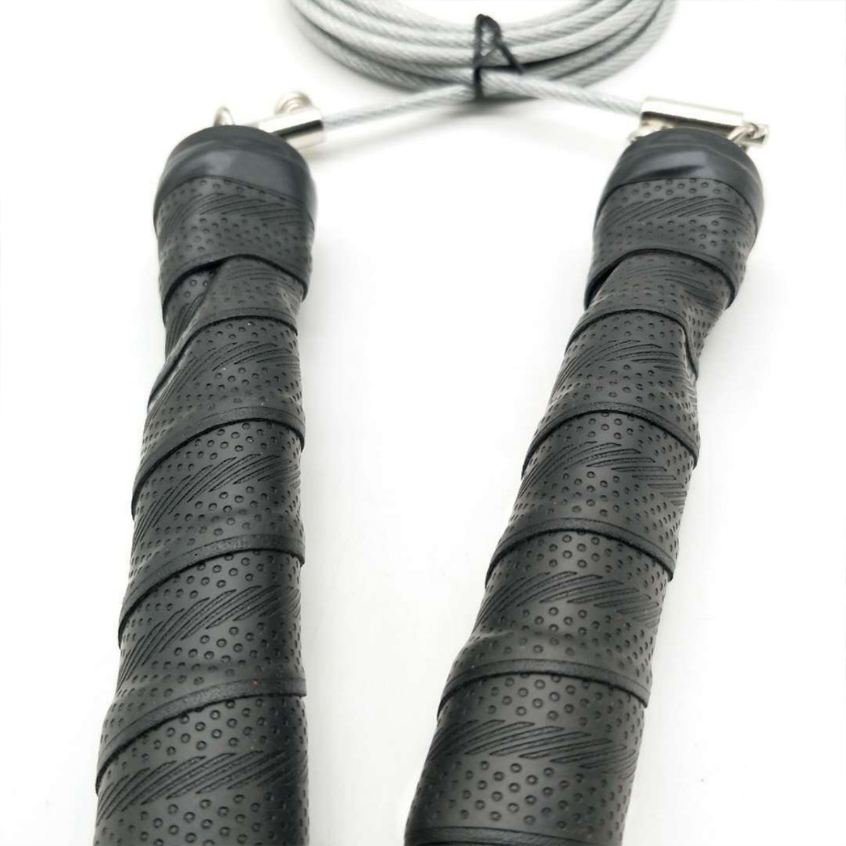 Schwarzes Springseil mit schwarzen, strukturierten Griffen. Das Seil ist silber.