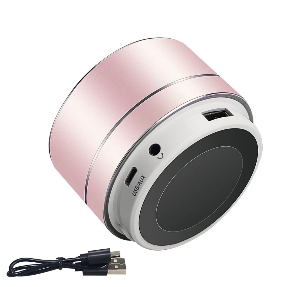 Roségoldener Mini-Lautsprecher mit USB/AUX-Anschlüssen und Ladekabel. Der Lautsprecher hat eine schwarze Oberseite.