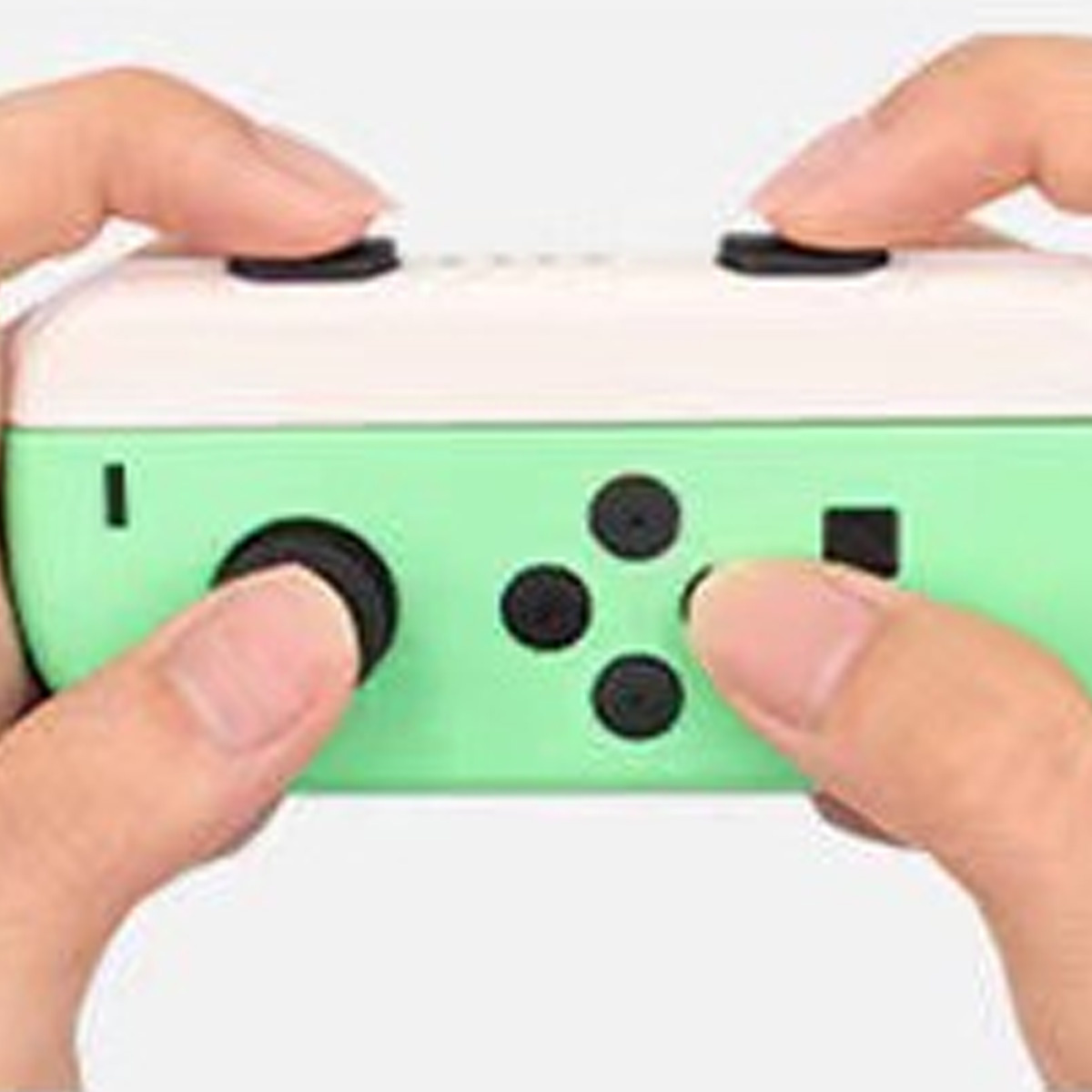 Eine Nahaufnahme eines weiß-grünen Gamecontrollers mit Händen, die ihn halten.