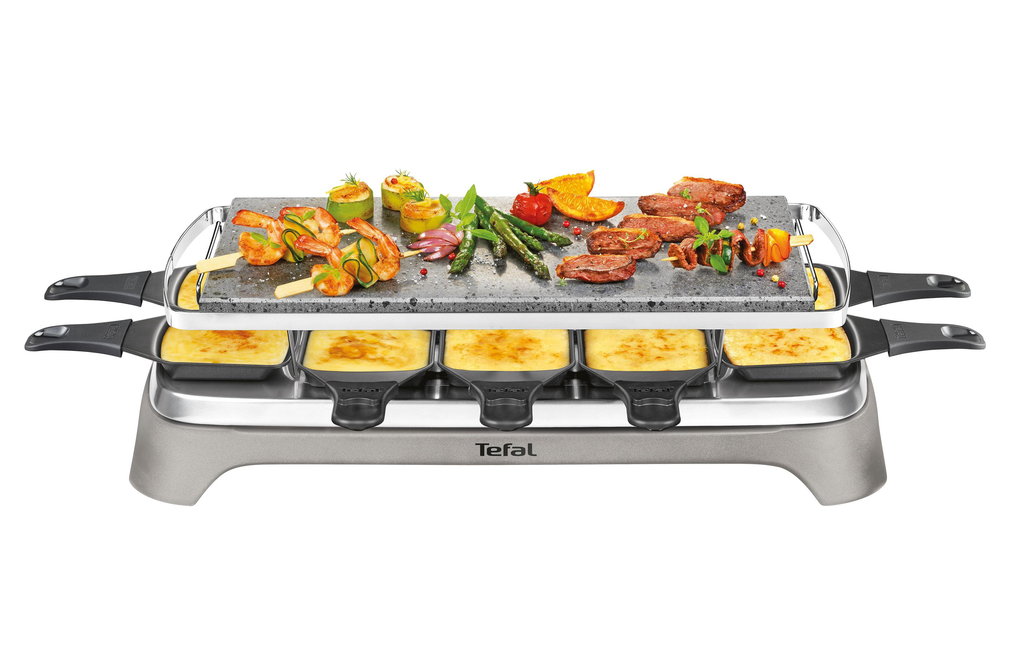 Grill do raclette z jedzeniem, w tym krewetkami, warzywami i mięsem.