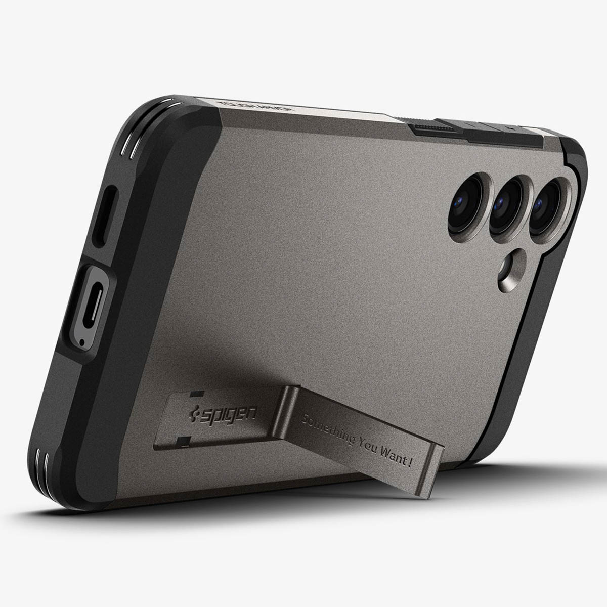 Coque de téléphone grise et noire avec béquille, logo de la marque et la phrase 'Something You Want!'