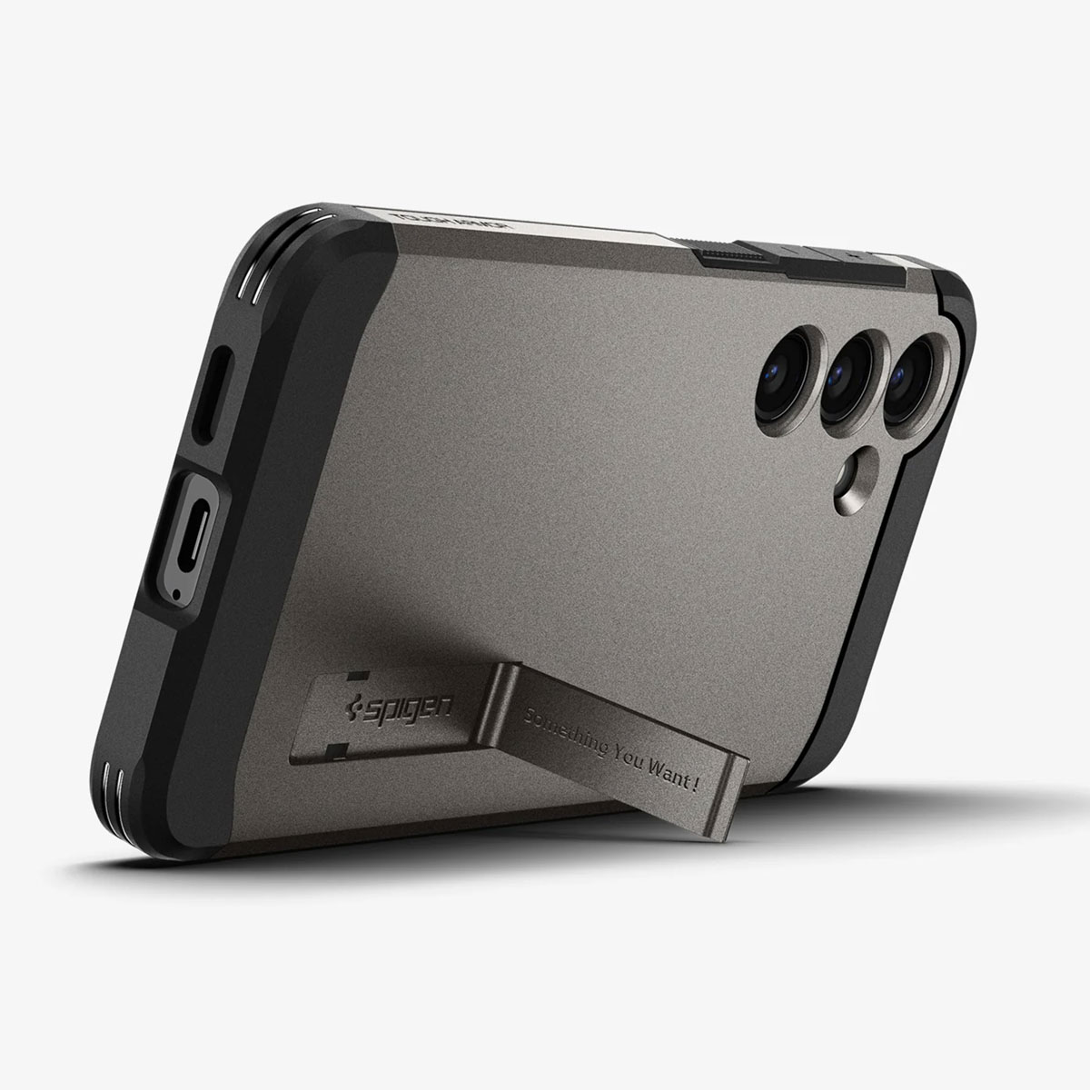 Grijze en zwarte telefoonhoes met standaard, merklogo en de tekst 'Something You Want!'