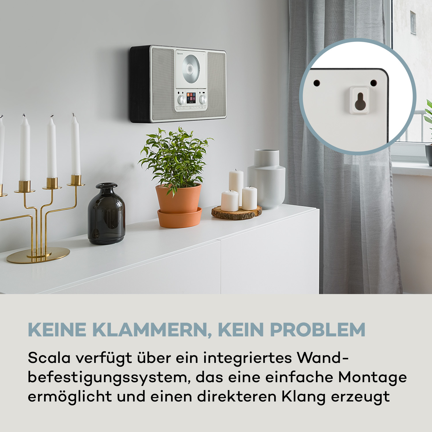 Stereoanlage auf weißem Schrank mit Dekoration.