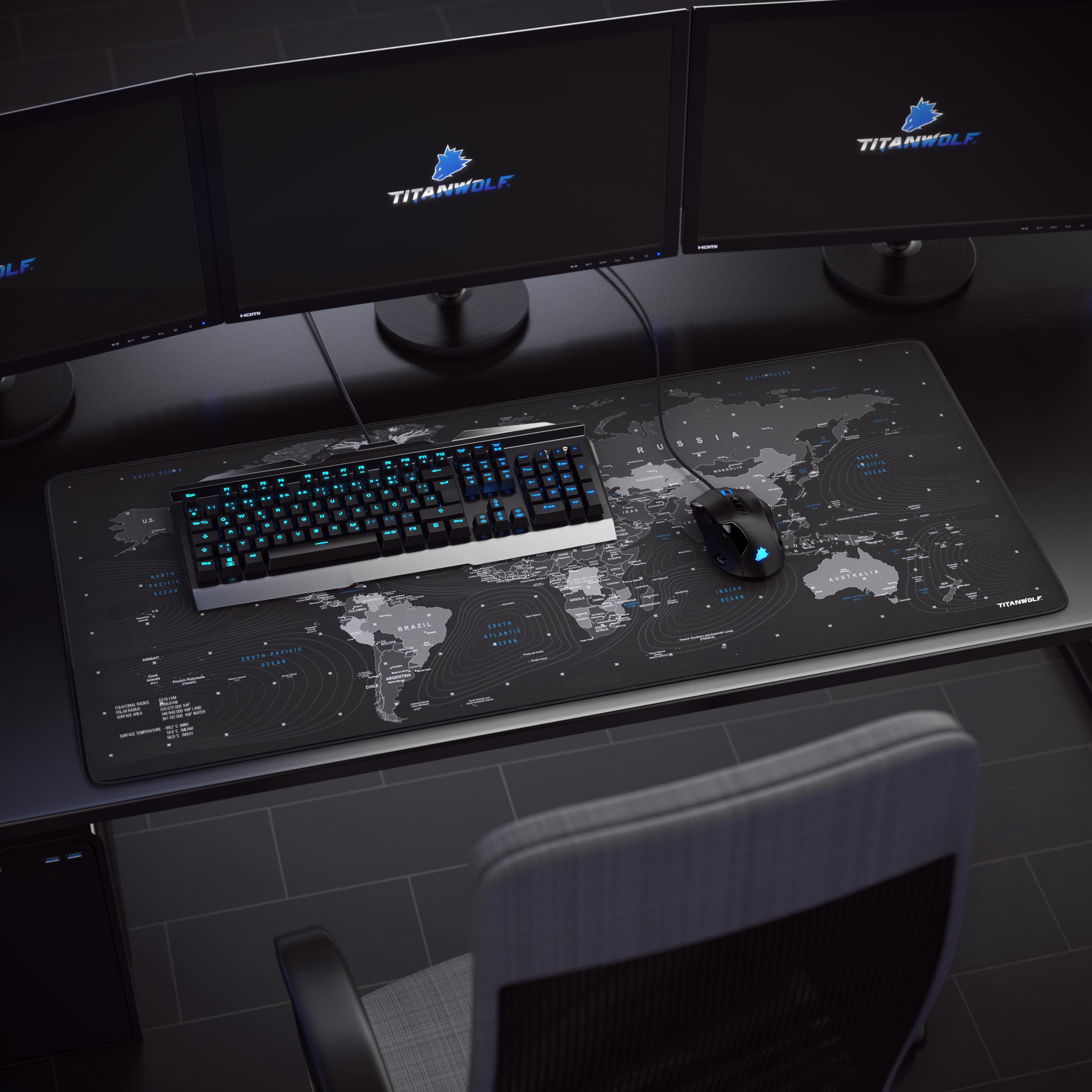 Gaming-Setup mit drei Monitoren, Tastatur, Maus und Mauspad mit Weltkarten-Design.