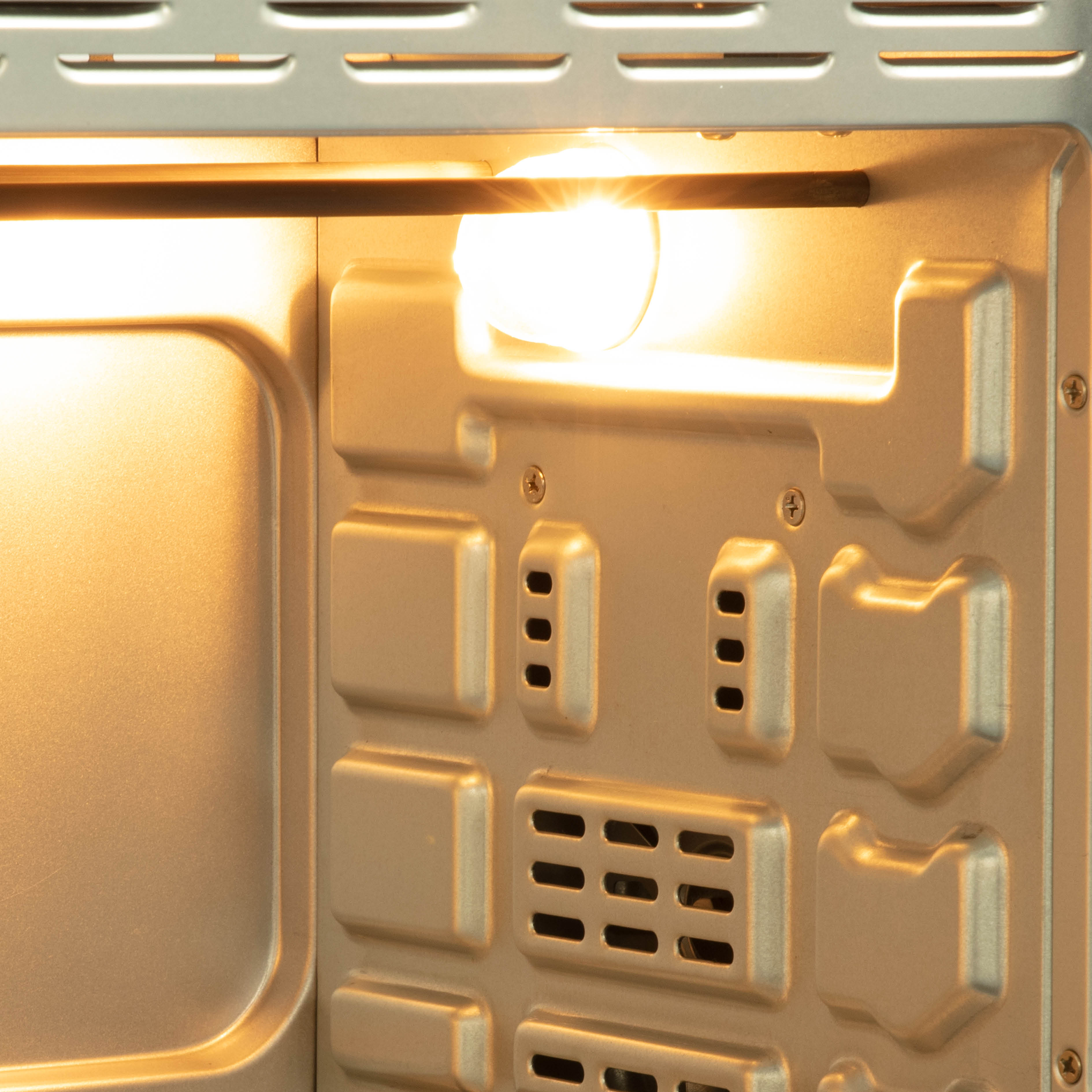 Inside of an oven with light on.