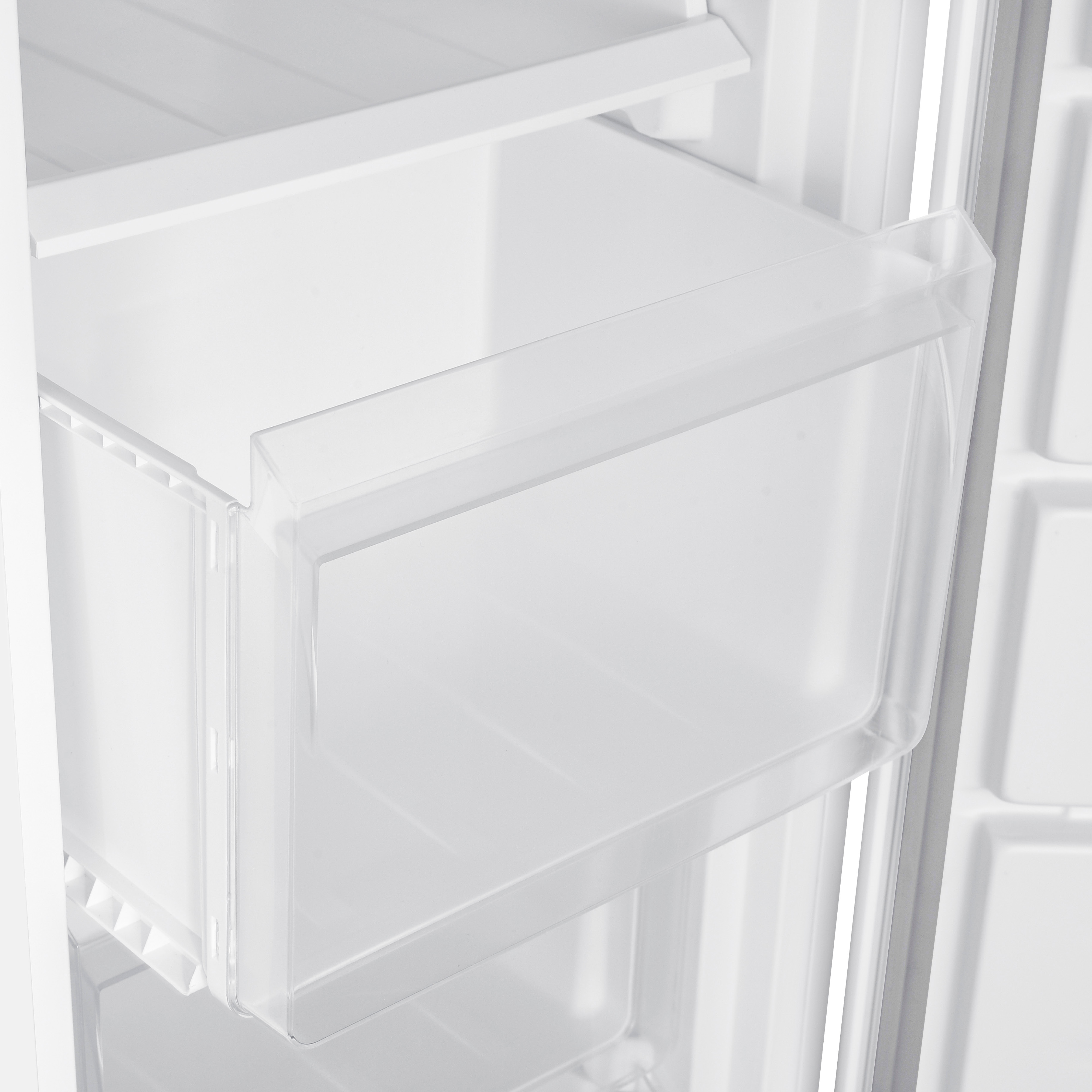 A white refrigerator interior with a clear, open drawer, providing storage space, is visible.