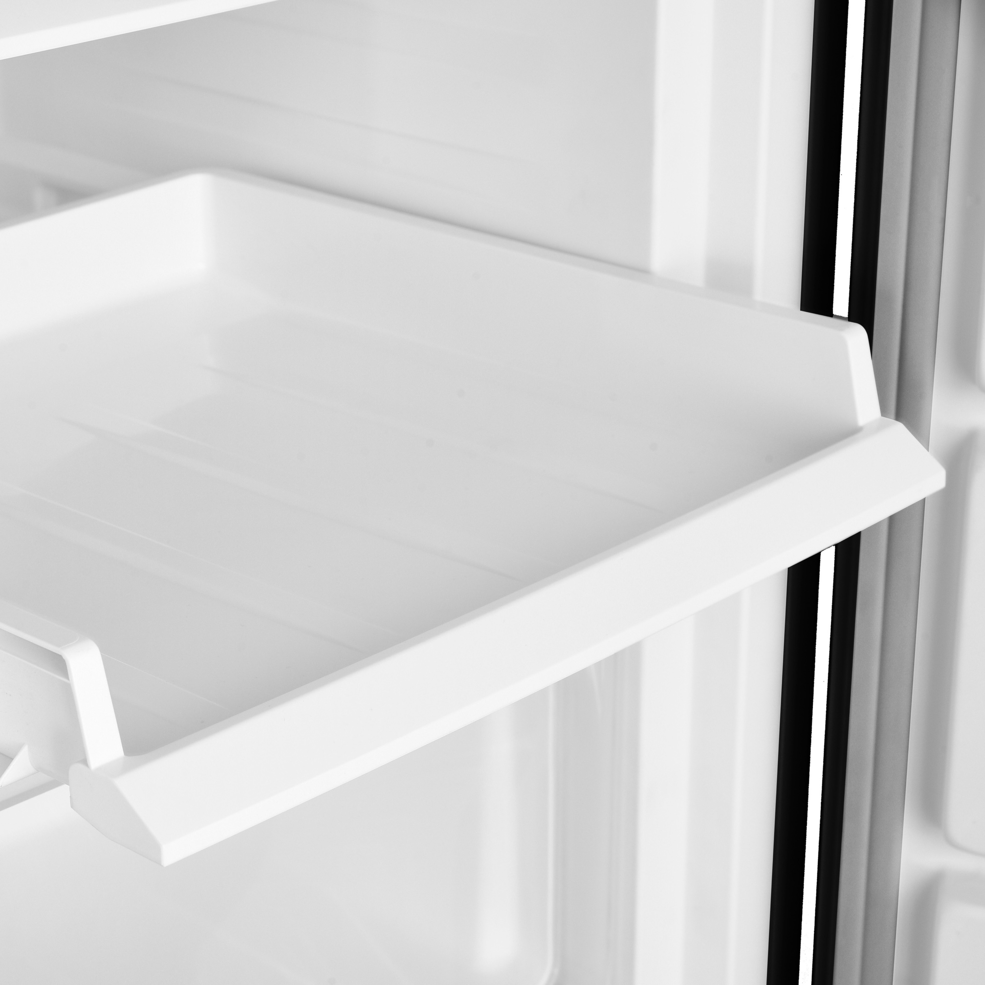 White refrigerator drawer. White walls, and a black border are visible.