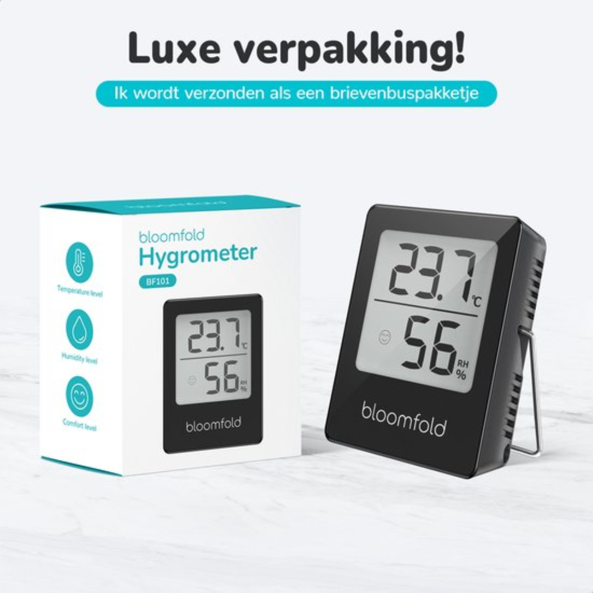 Ein Hygrometer mit Anzeige von Temperatur und Luftfeuchtigkeit, neben einer Box.