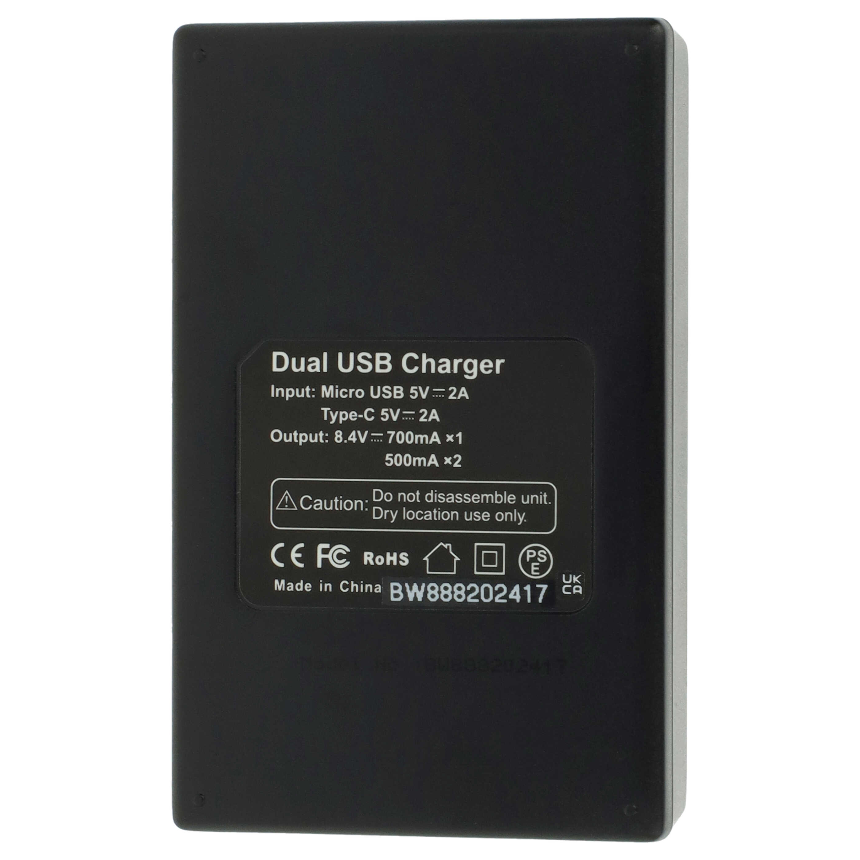 Schwarzes Ladegerät mit Etikett: Dual-USB-Ladegerät. Text enthält Eingabe, Ausgabe und Vorsichtshinweise.