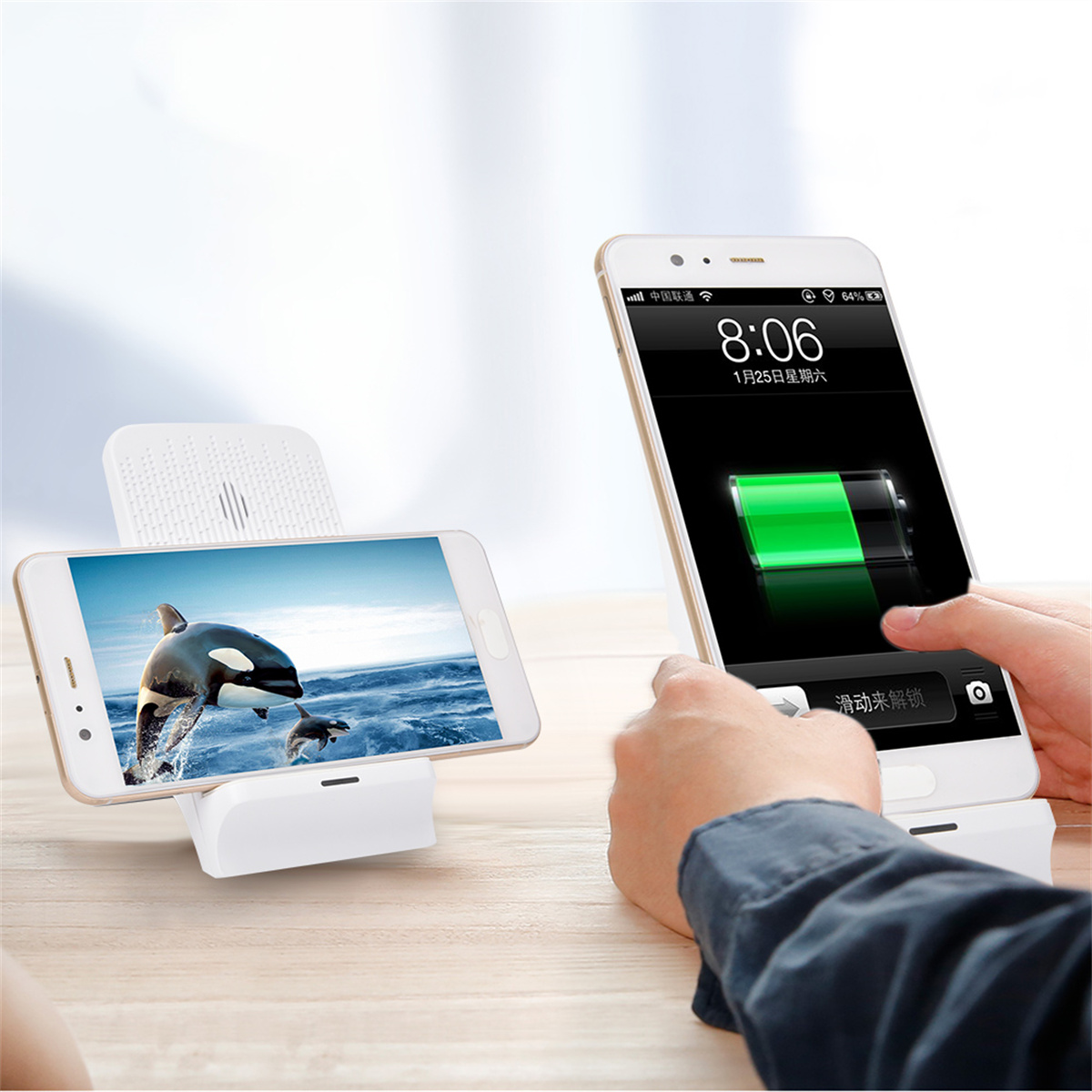 Zwei Smartphones, eines lädt an einer weißen Dockingstation, das andere in der Hand, mit grünem Akku.