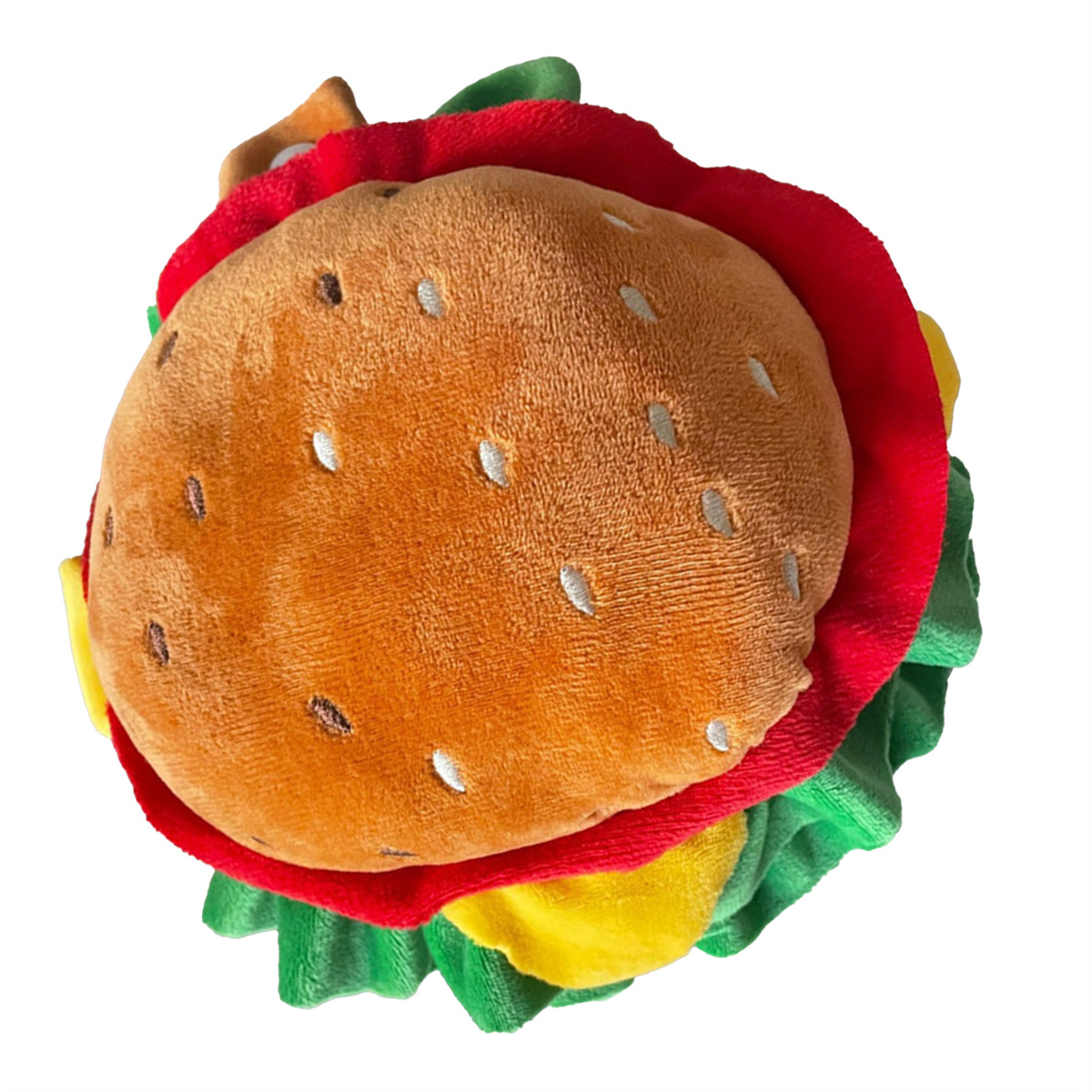 Ein Plüsch-Burger-Spielzeug mit braunem Brötchen, rotem Salat, gelbem Käse und weißen Sesamkörnern.