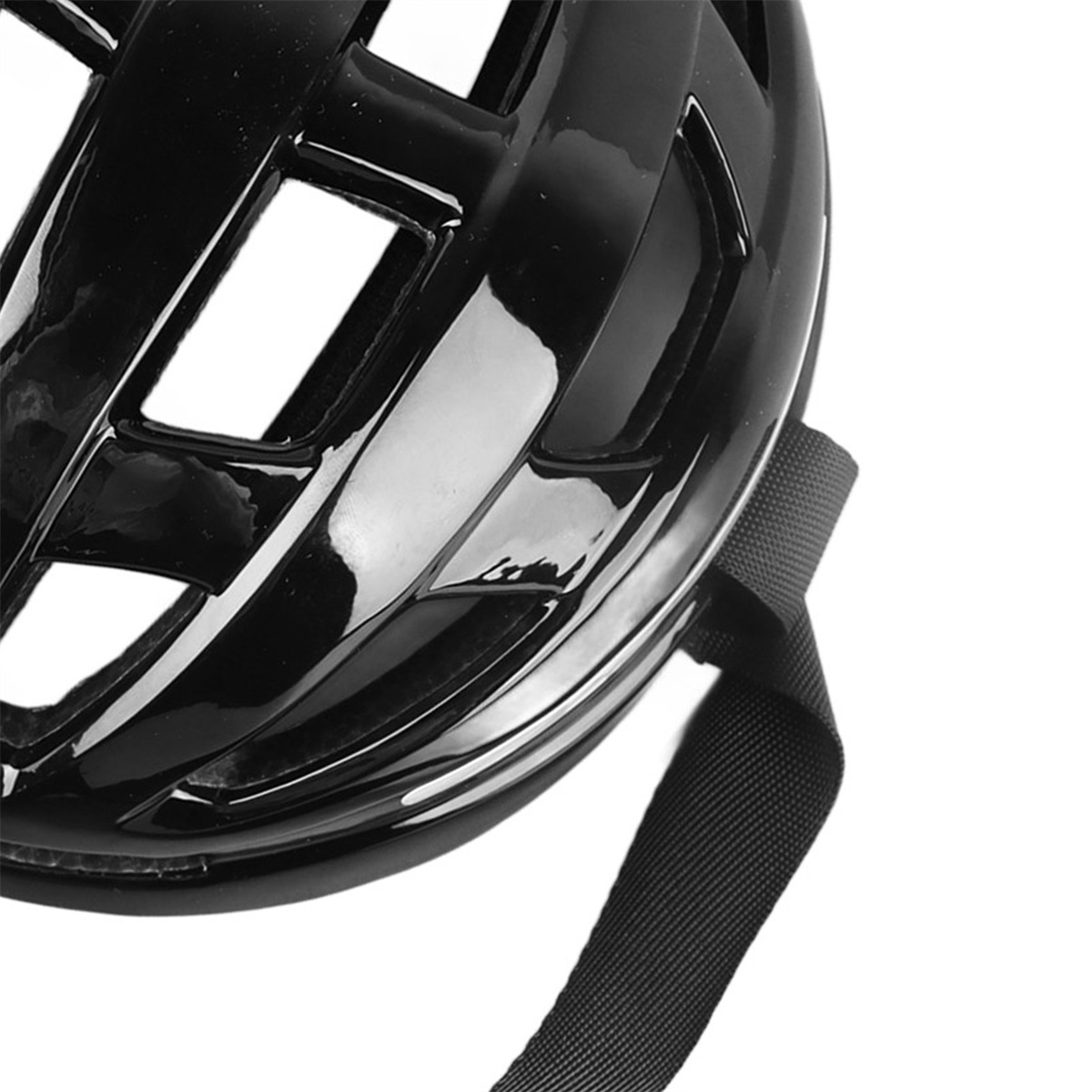 Schwarzer glänzender Fahrradhelm mit Riemen. Er hat Belüftungsöffnungen und ist vor weißem Hintergrund.