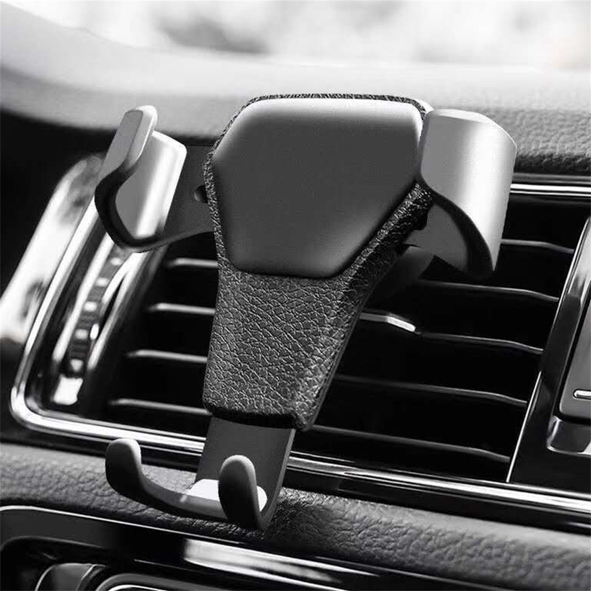 Schwarzer Autotelefonhalter, der in der Lüftung des Autos installiert ist.