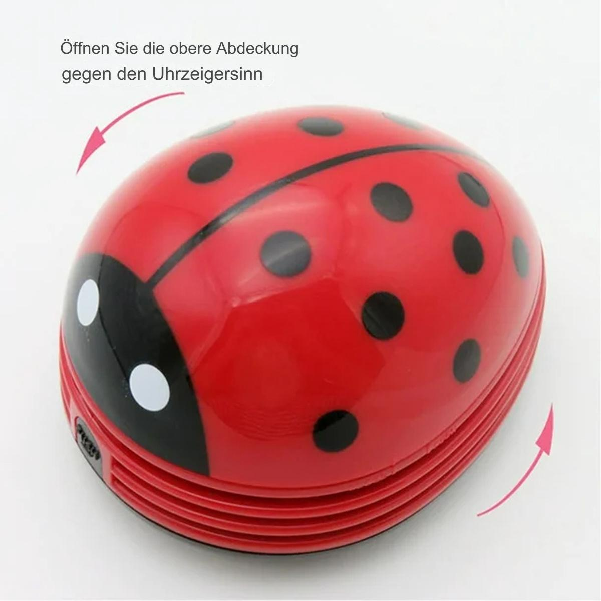 Roter Marienkäfer-förmiger Reiniger mit schwarzen Punkten, Text und Pfeilen, die die Öffnungsrichtung anzeigen.