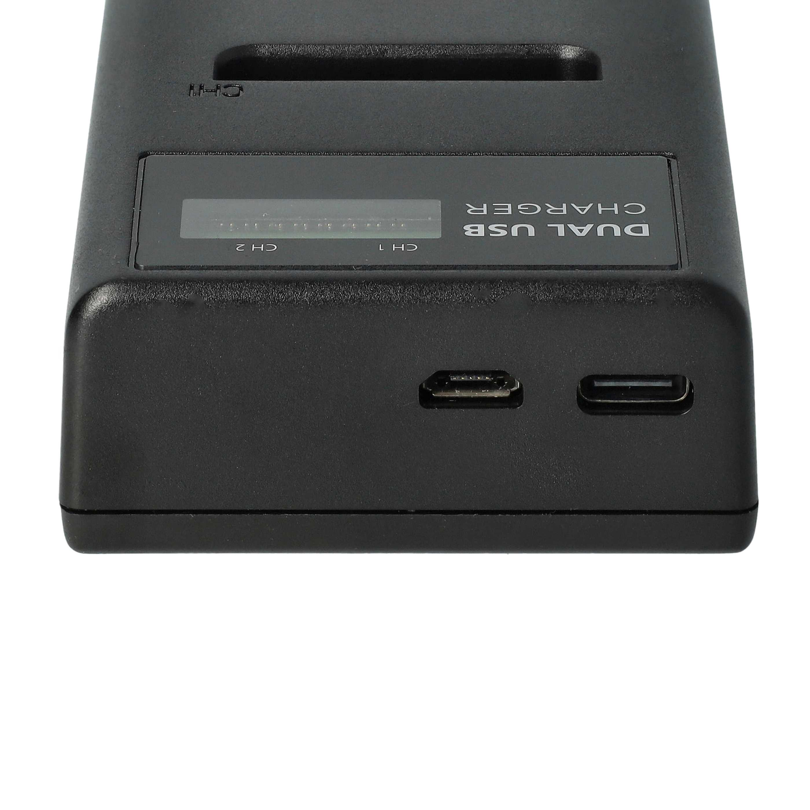 Schwarzes Dual-USB-Ladegerät mit Bildschirm, USB- und Micro-USB-Anschlüssen, auf weißem Hintergrund.