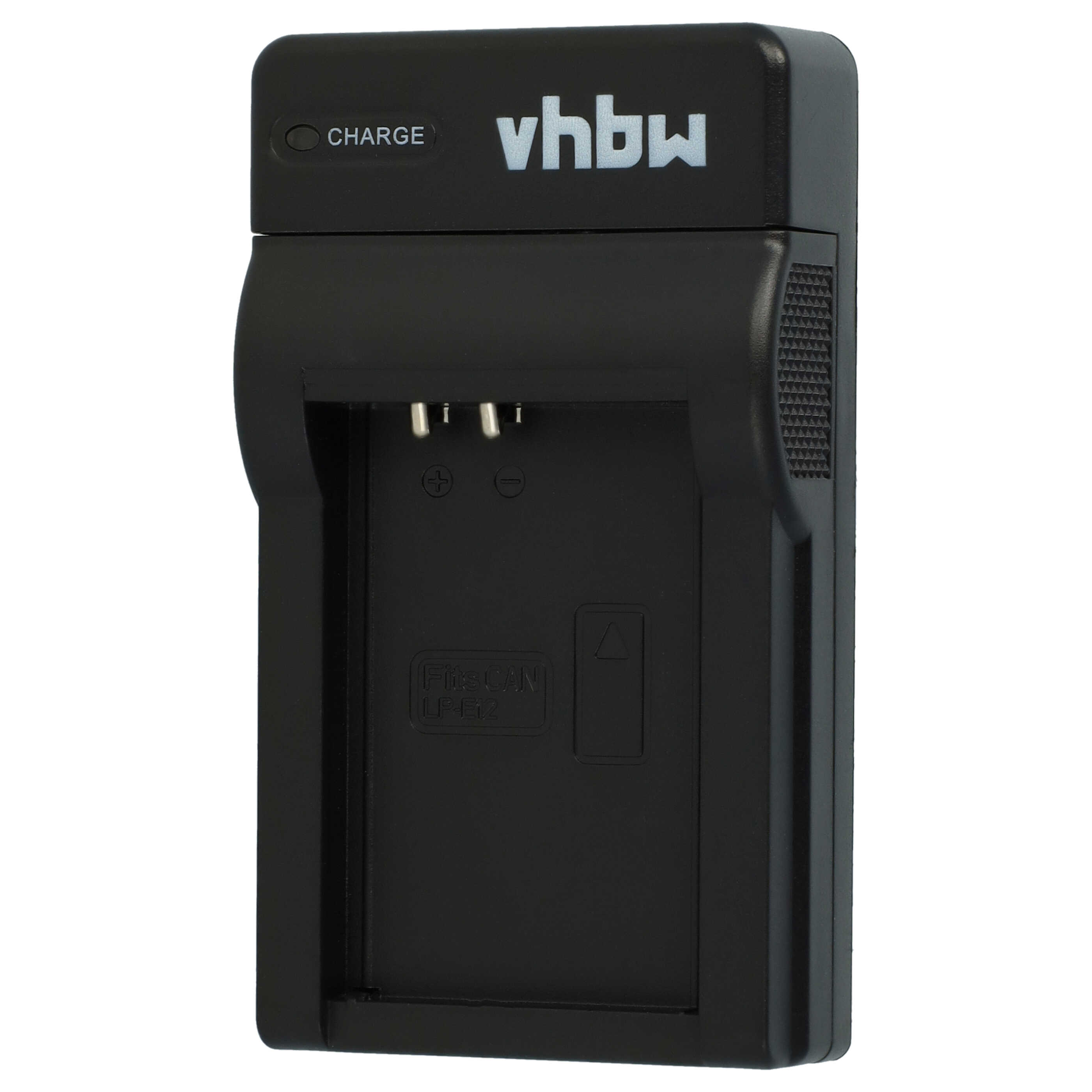 Ein schwarzes Kamera-Akkuladegerät mit der Aufschrift 'vhbw' sowie Ladeanzeigen und Pins.