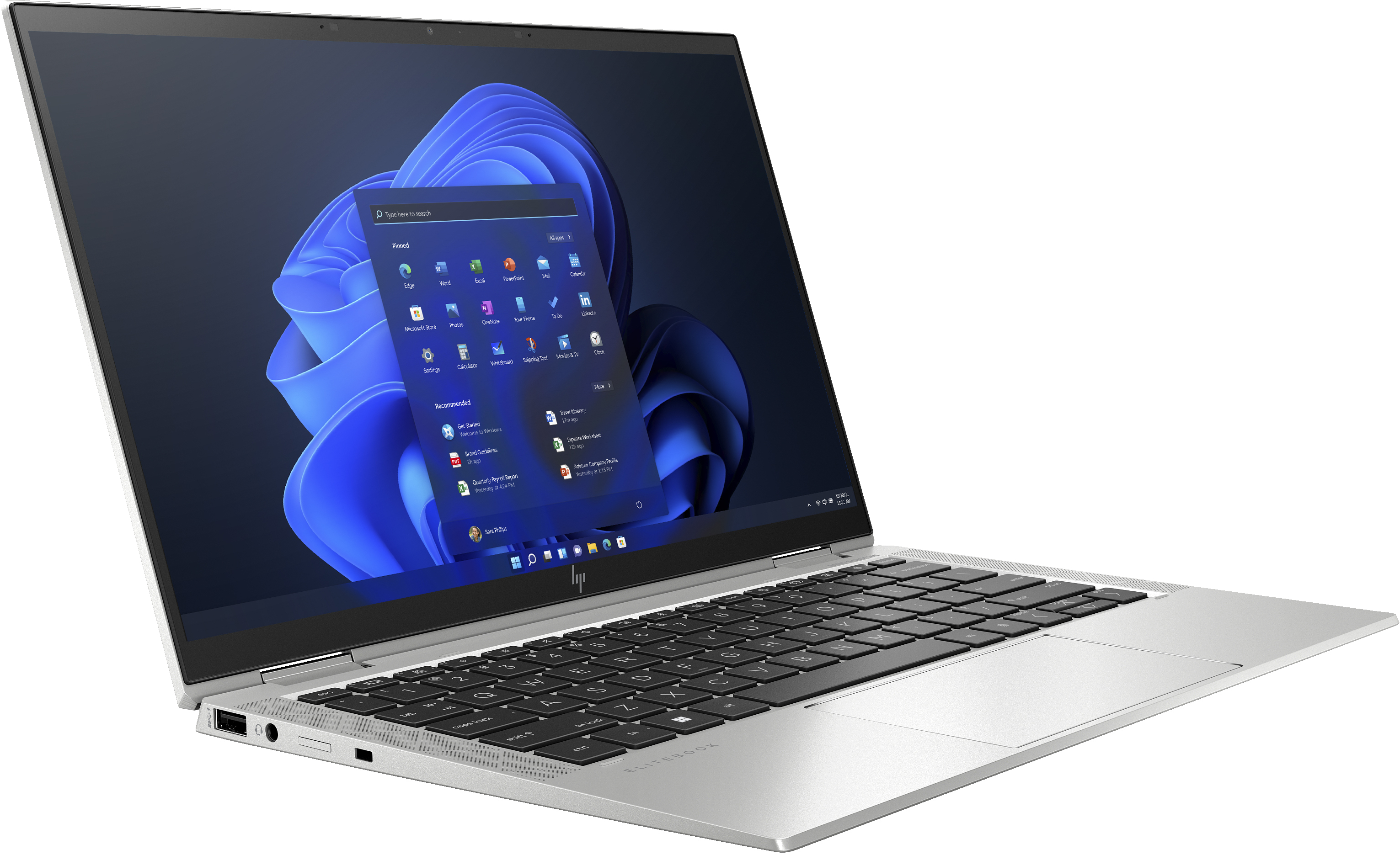 Una laptop plateada abierta sobre un escritorio, mostrando la pantalla con la interfaz de Windows 11.