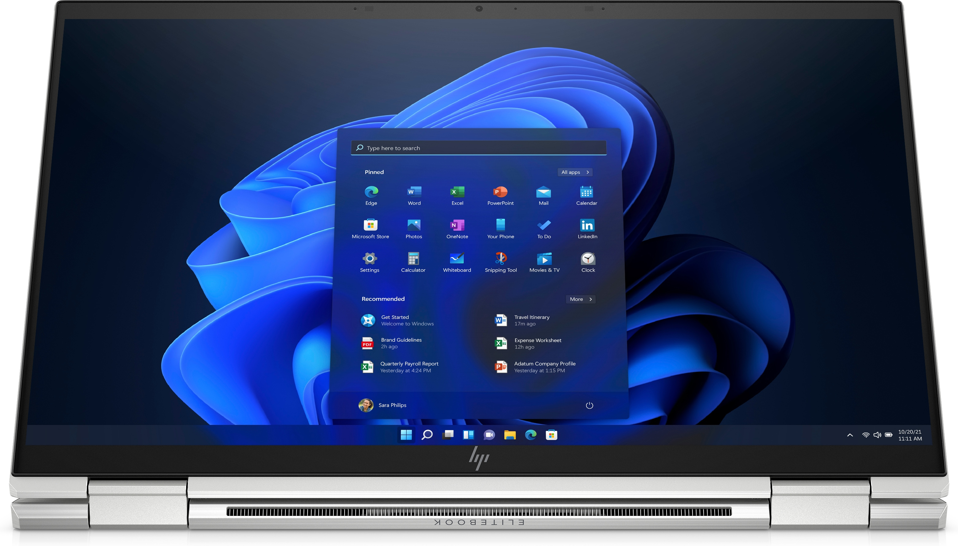 Pantalla de portátil que muestra la interfaz de Windows 11. Marco plateado, fondo blanco.