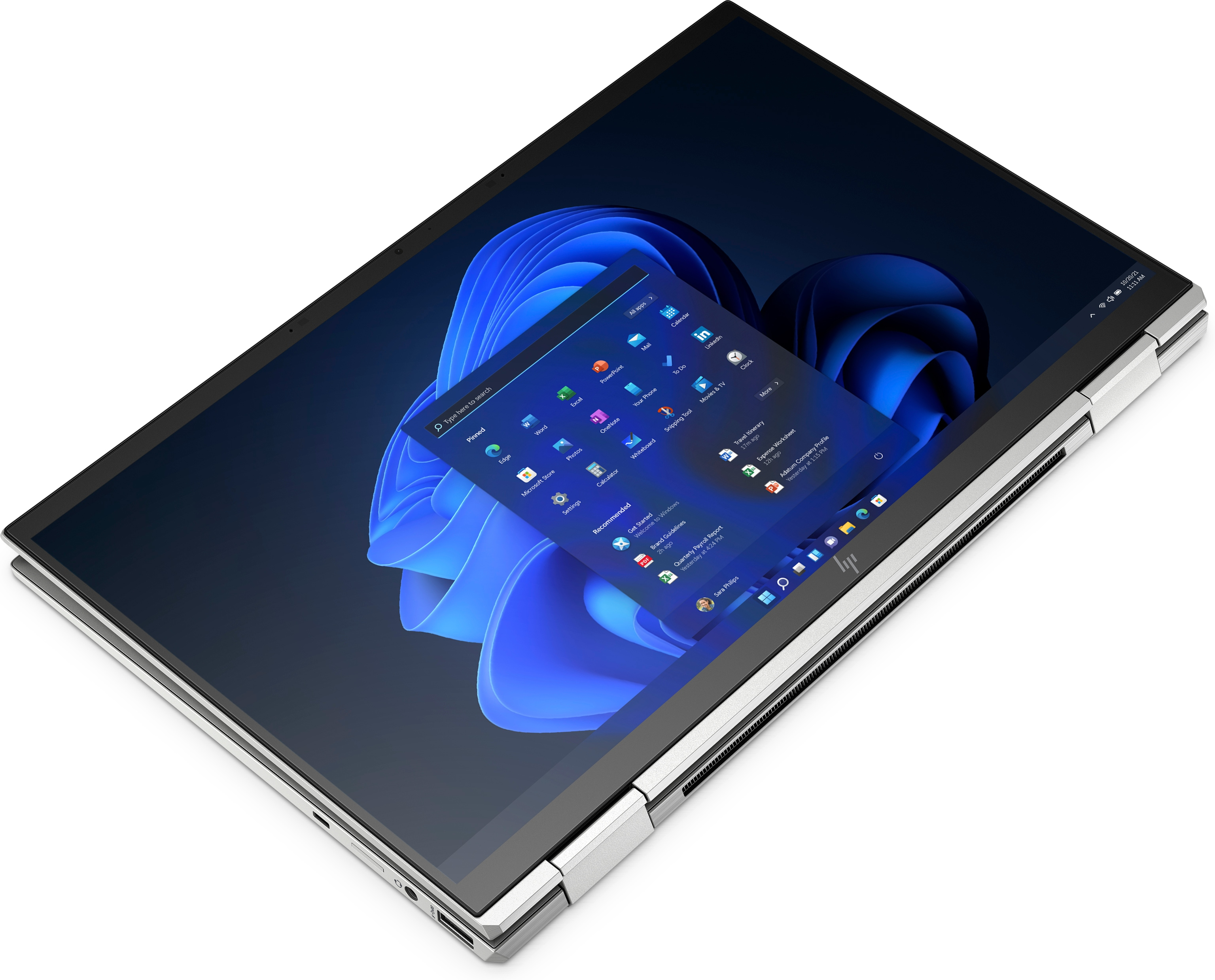 Una computadora portátil que muestra una interfaz de Windows, abierta sobre una superficie blanca, mostrando iconos de aplicaciones.