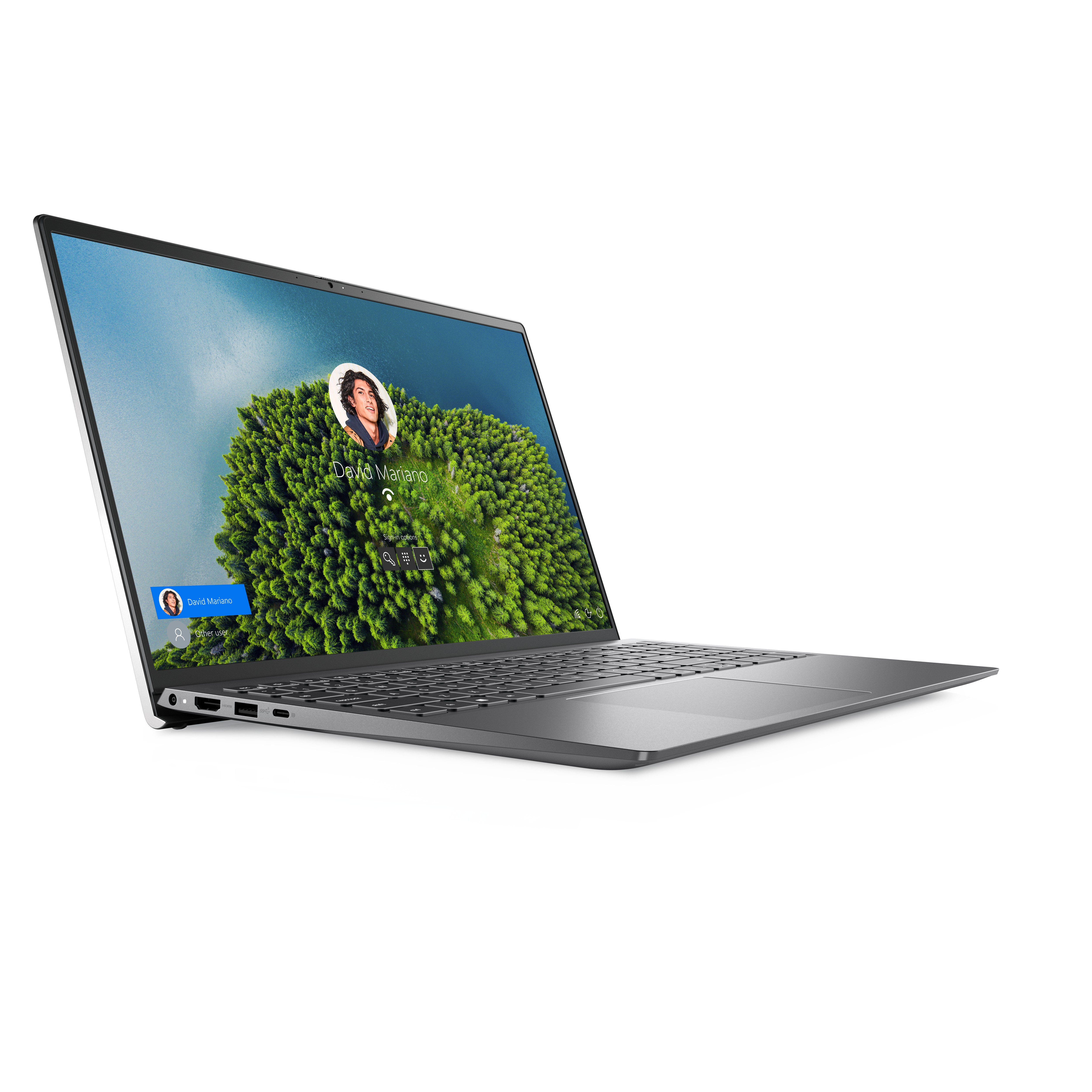 Il laptop mostra una schermata di accesso al profilo. Lo sfondo è un paesaggio verde sfocato.