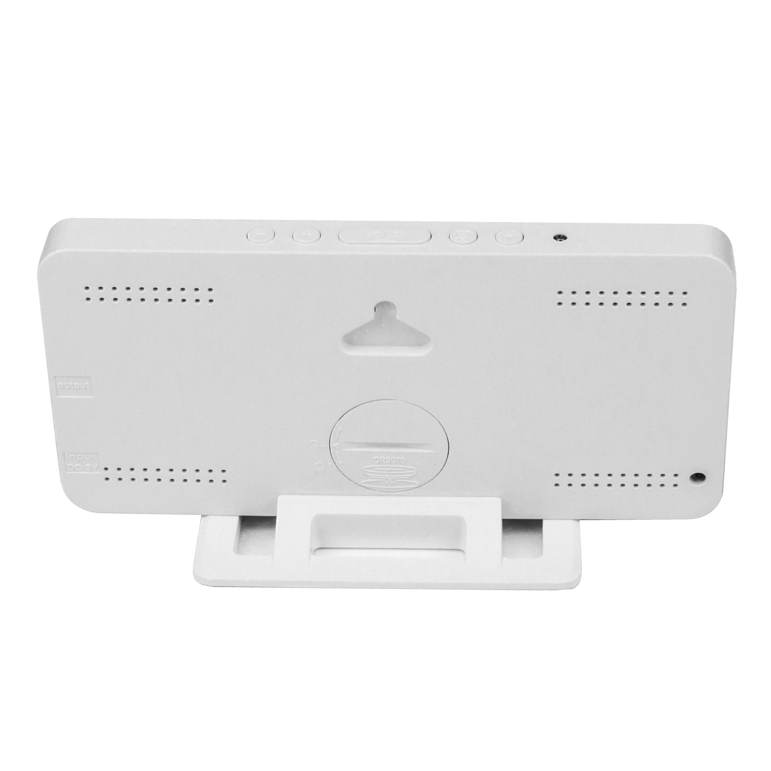 Back view of a white digital clock with buttons and stand.