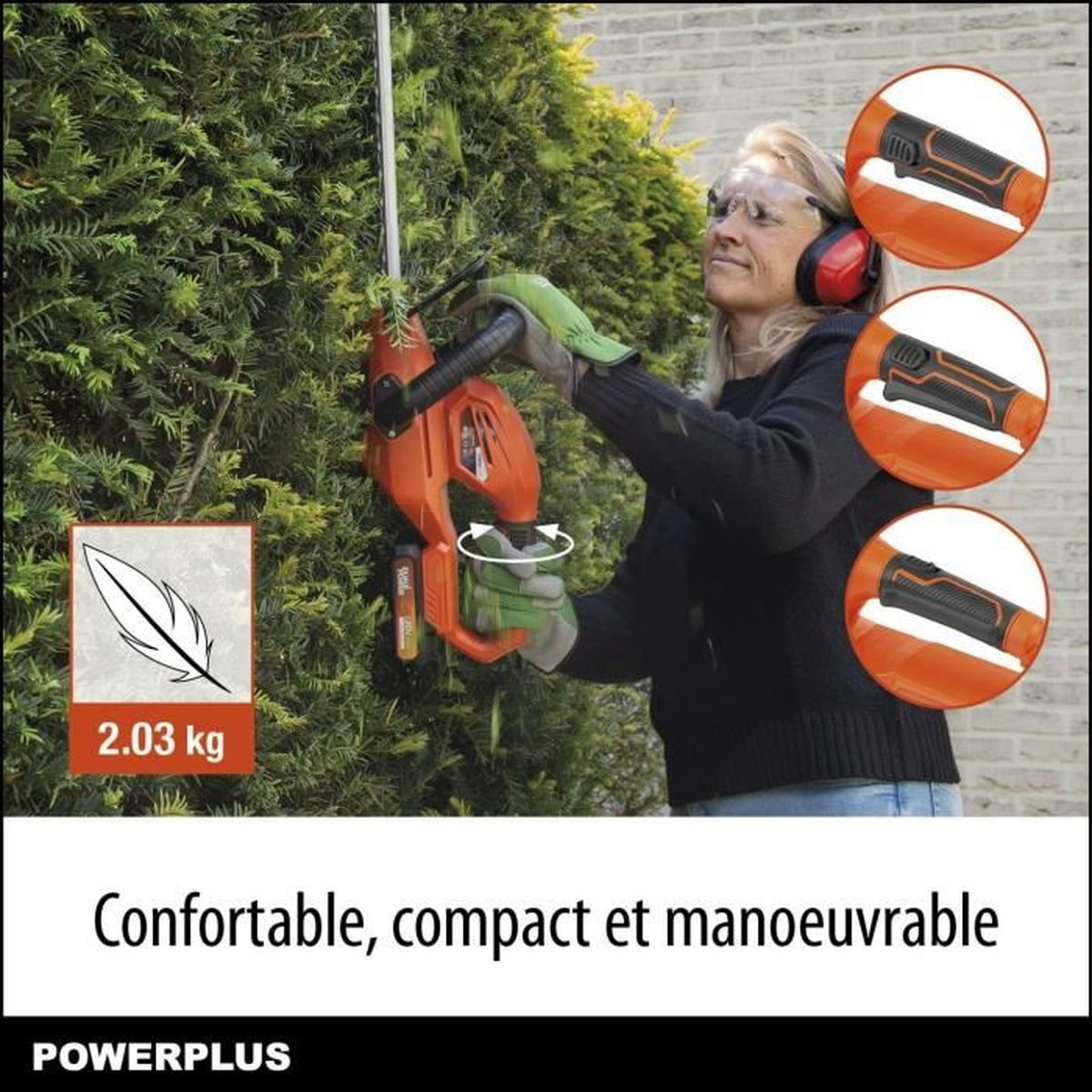 Eine Frau benutzt eine Heckenschere an einer Hecke. Die Heckenschere ist orange, und die Frau trägt Schutzkleidung.
