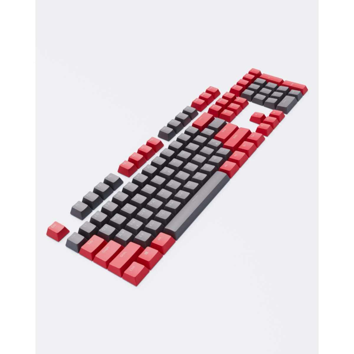 Eine zerlegte mechanische Tastatur mit roten und grauen Tastenkappen auf weißem Untergrund, verstreut.