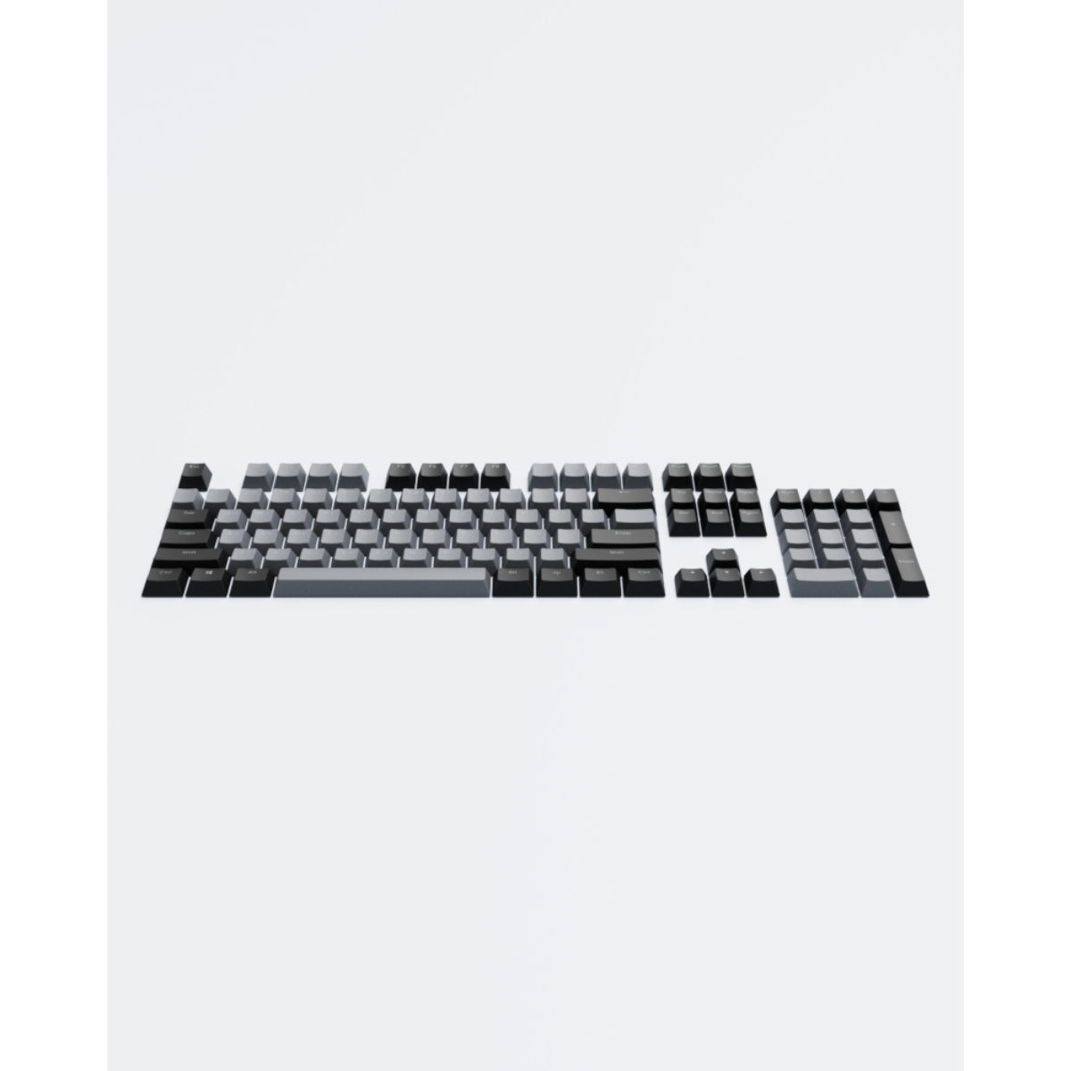 Tastenkappen, getrennt von einer Tastatur, auf weißem Untergrund angeordnet. Die Tasten sind grau und schwarz.