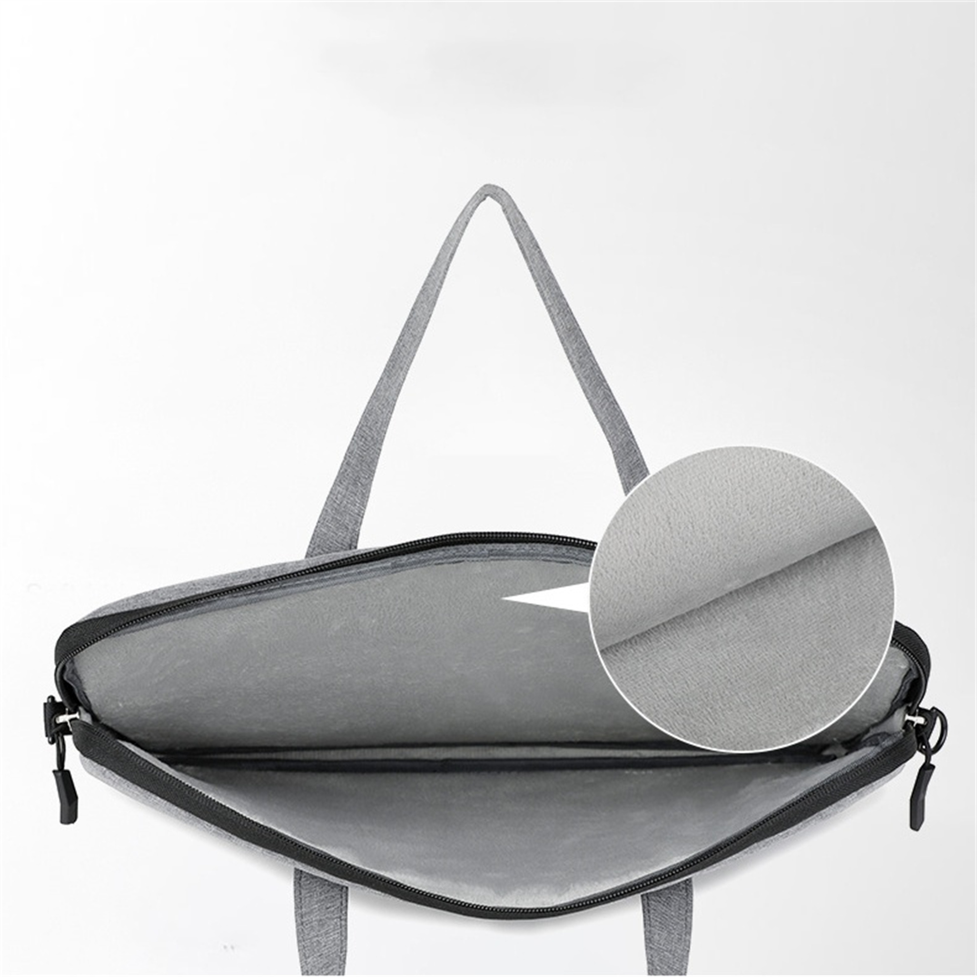 Graue Laptoptasche, offen. Innenraum sichtbar, mit Nahaufnahme des Futters. Weißer Hintergrund.