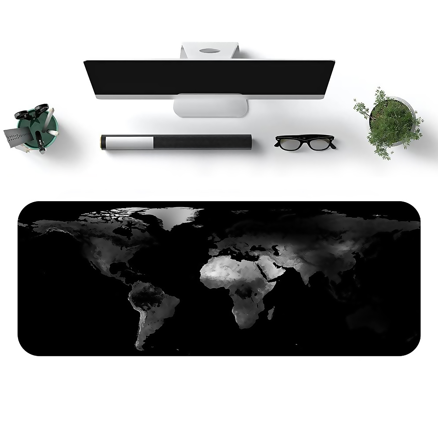 Vista superior de escritorio con monitor, bolígrafo, gafas y planta. Alfombrilla de ratón de mapa del mundo.