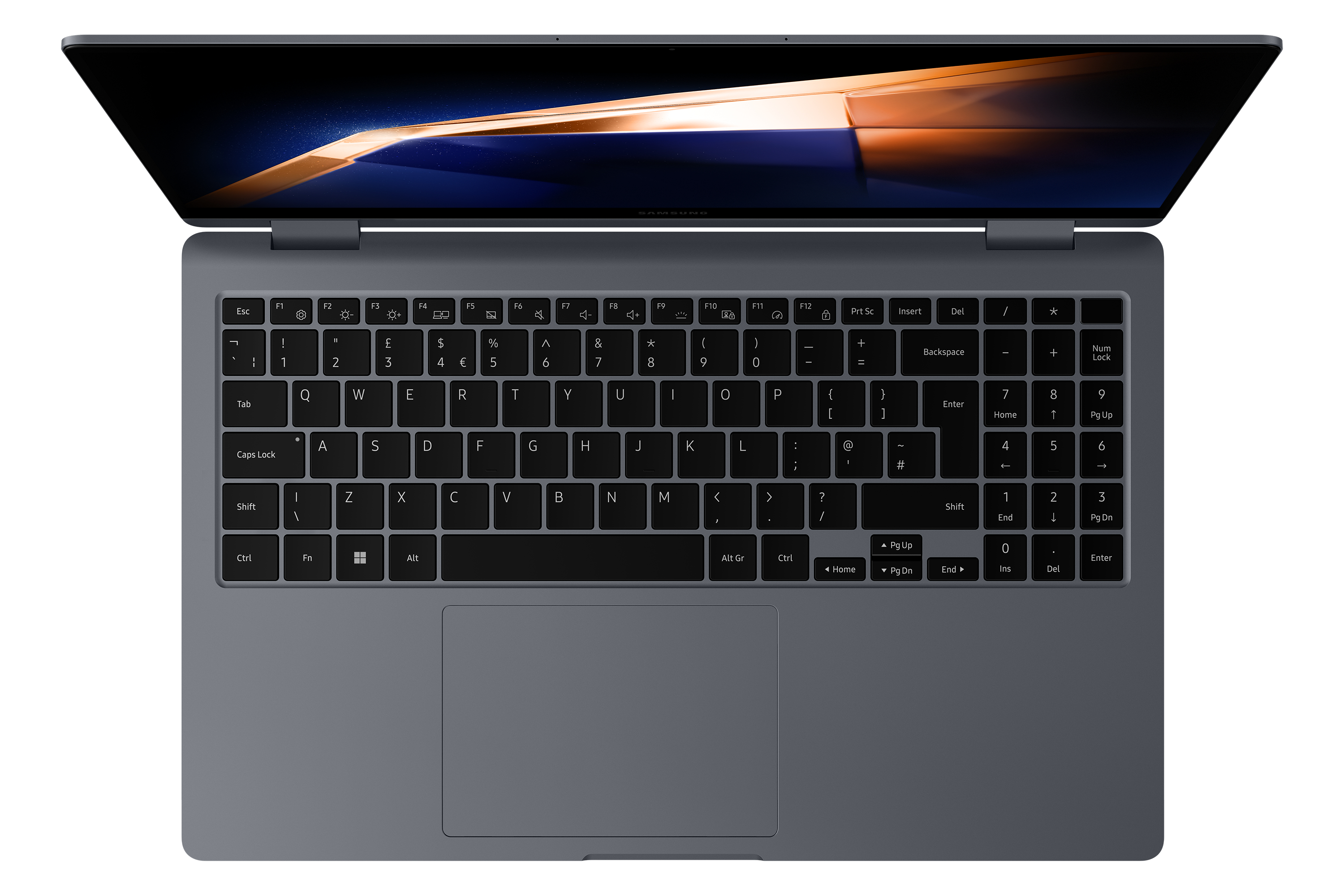 Draufsicht auf einen grauen Laptop mit Tastatur und Touchpad auf dunklem Hintergrund.