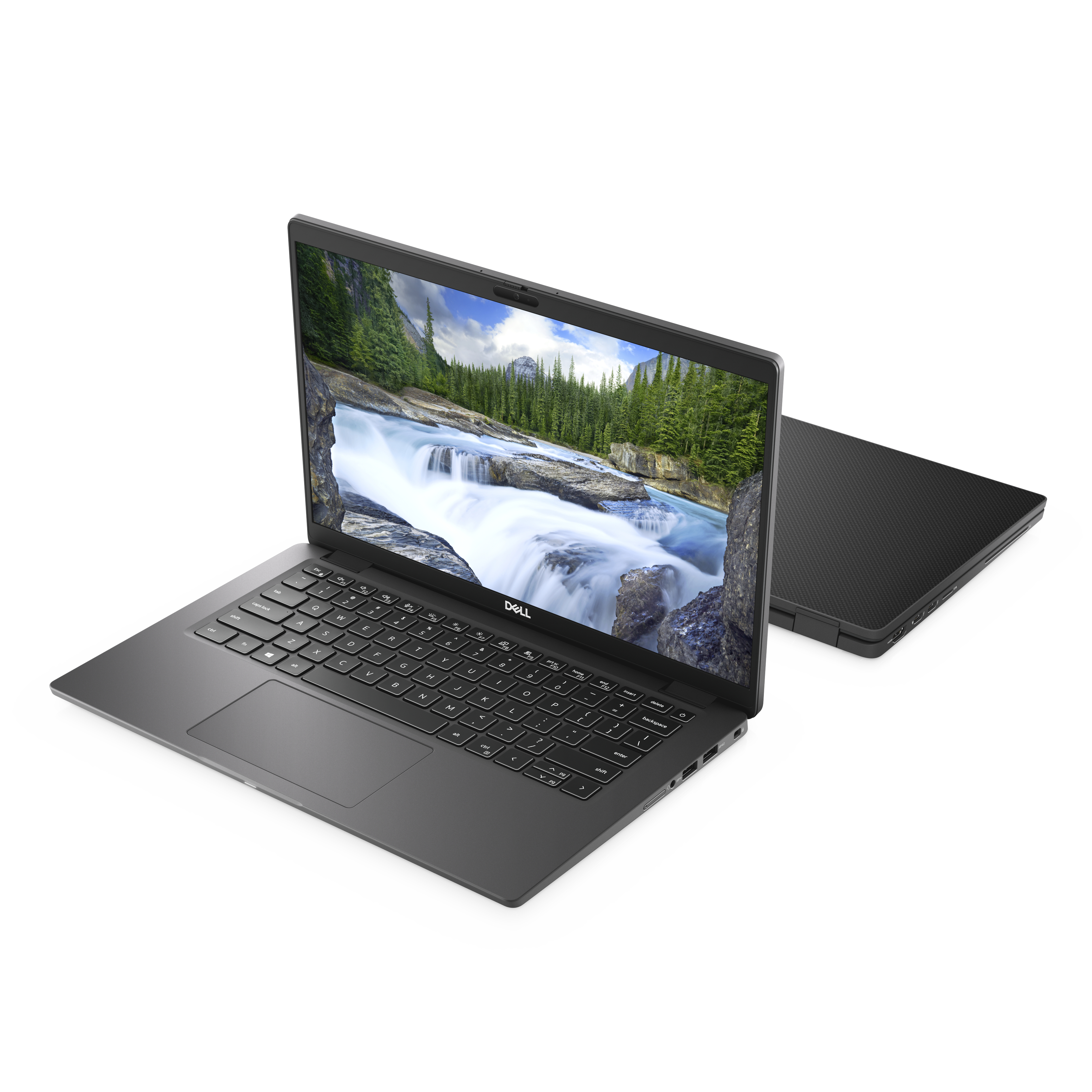 A gray laptop with an open screen, showing a waterfall scene, and a closed laptop in the background.