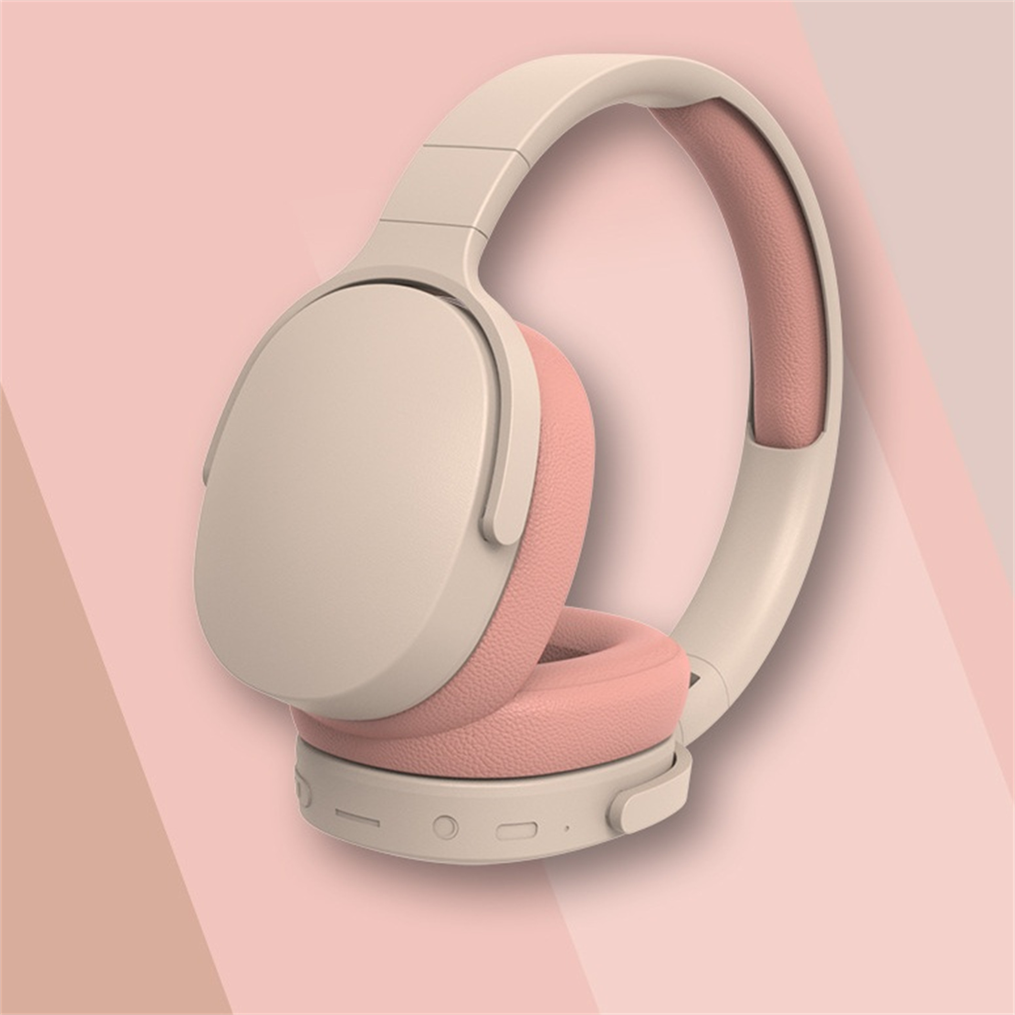 Drahtlose Kopfhörer, creme und rosa, auf rosa Hintergrund. Ohrmuscheln sind rosa, Kopfband und Rahmen sind creme.