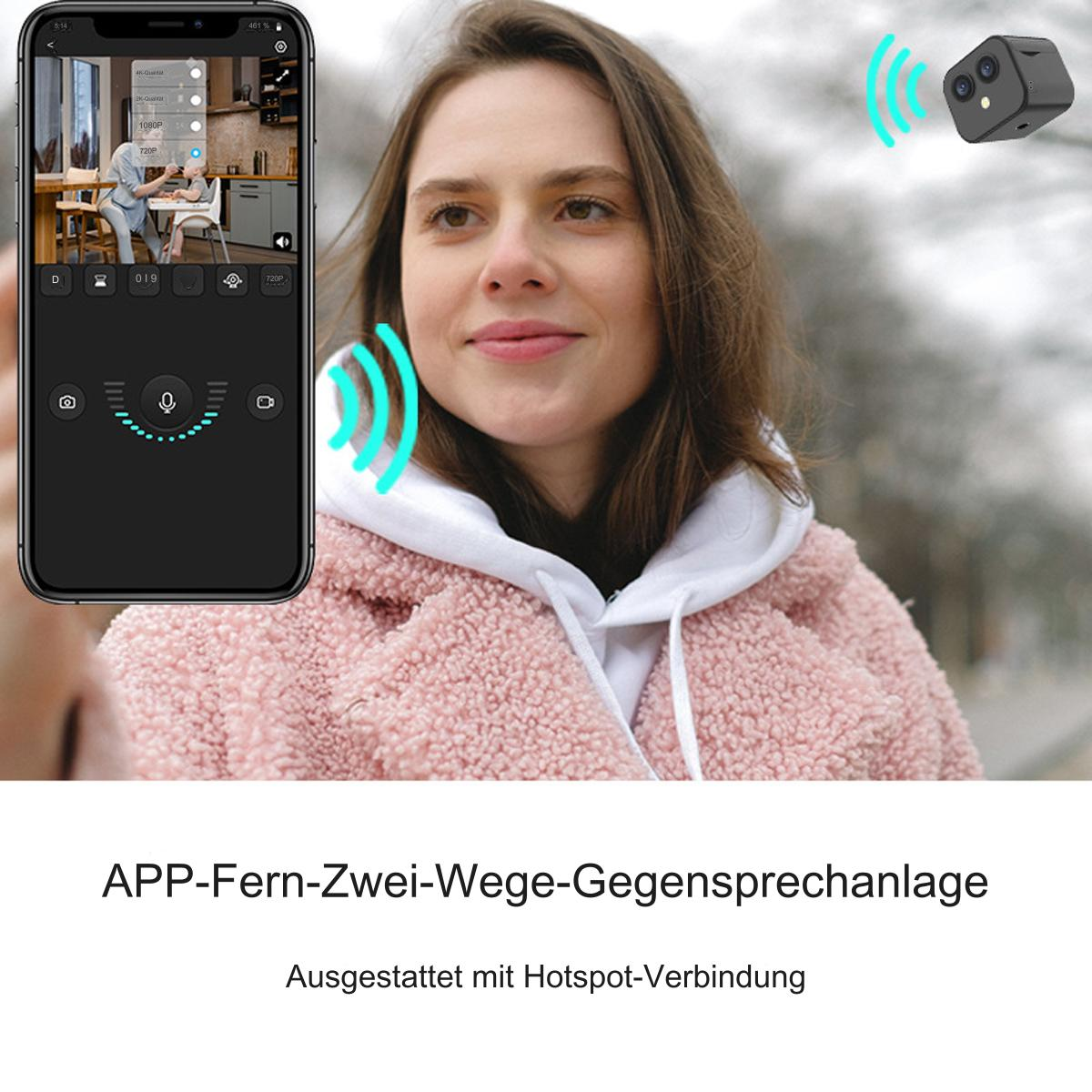 Frau mit Telefon und drahtloser Kamera. Das Telefon zeigt eine Überwachungsoberfläche.