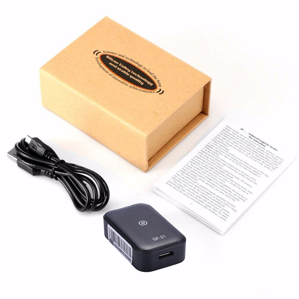 Kleiner schwarzer GPS-Tracker mit Box, USB-Kabel und einem Dokument auf weißer Oberfläche.
