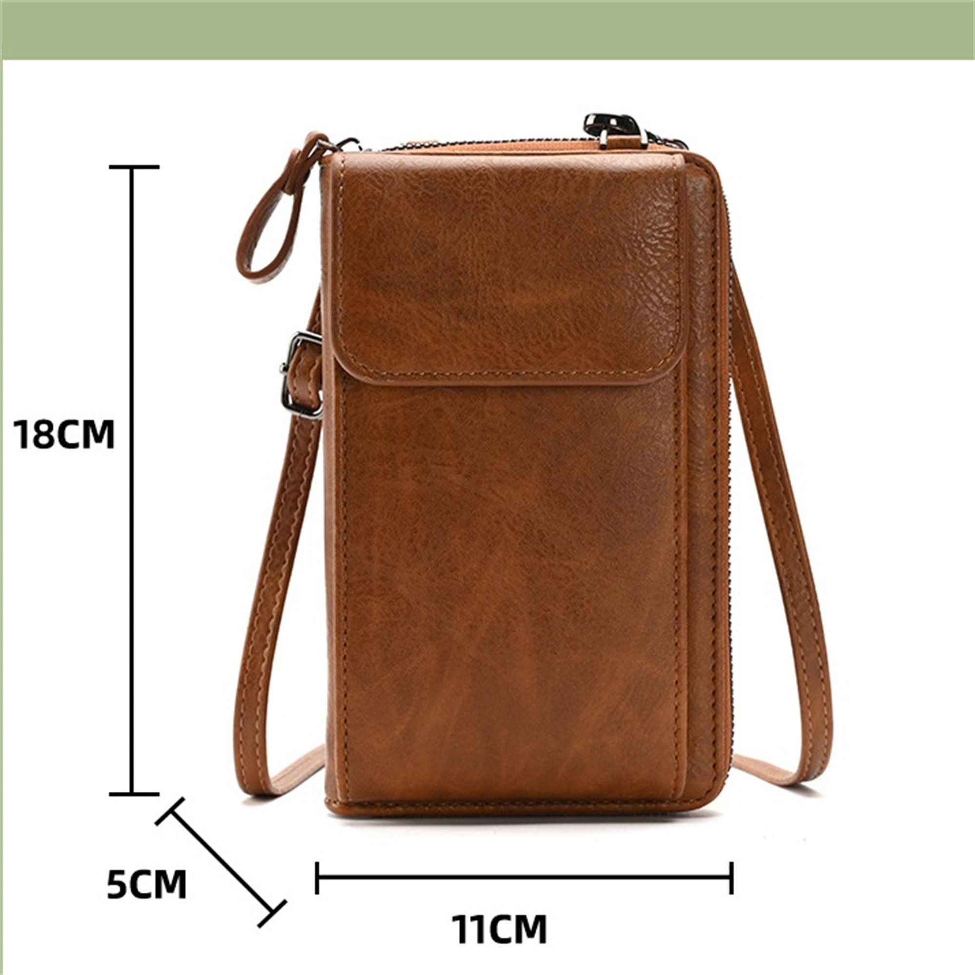 Braune Ledertasche mit Abmessungen. Ein langer Riemen und Reißverschluss sind sichtbar.