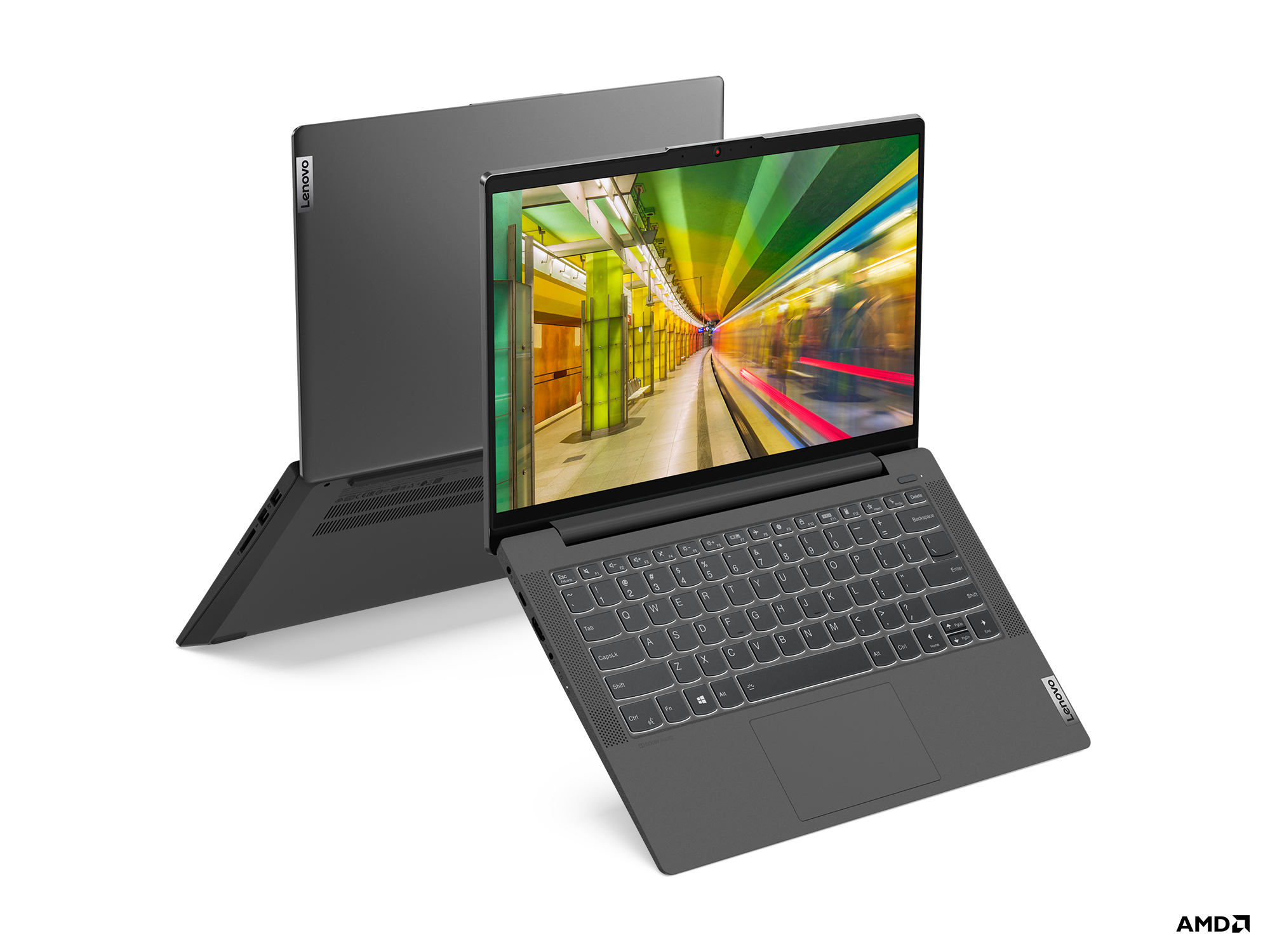 Un laptop Lenovo grigio aperto mostra uno schermo colorato, con un altro laptop chiuso dietro.