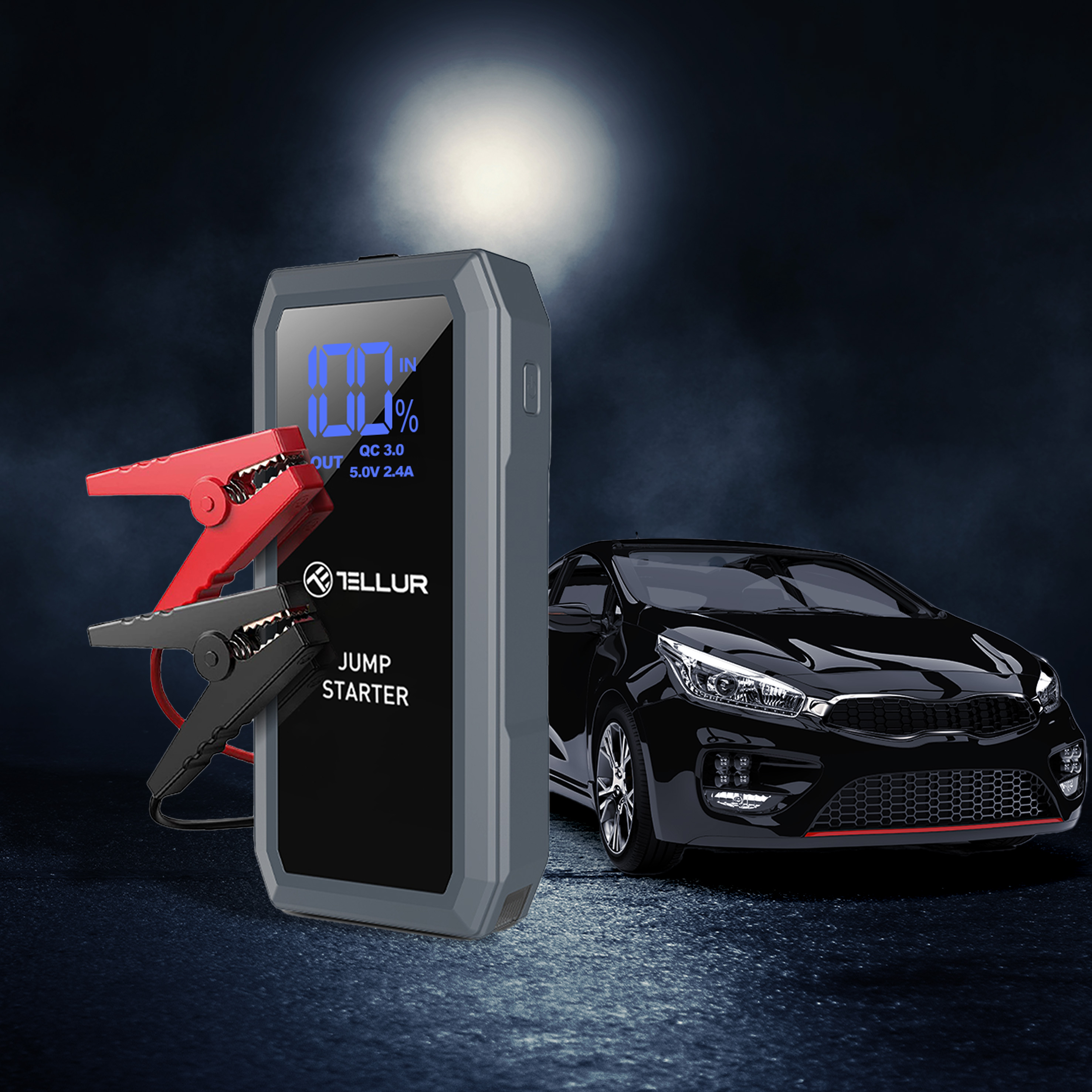 Rozrusznik z zaciskami i samochodem w tle. Rozrusznik wyświetla procenty.