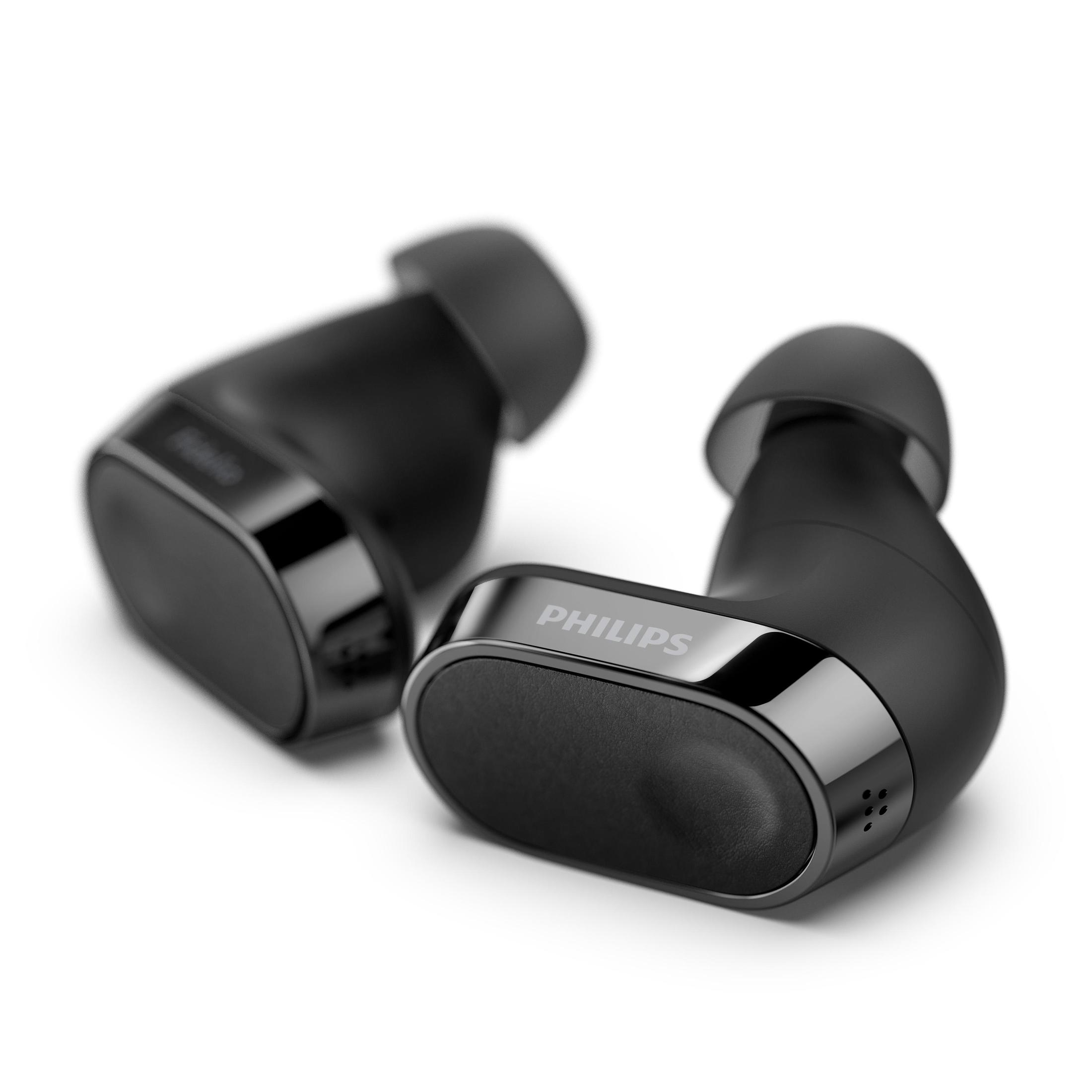 Dos auriculares negros Philips. Los auriculares tienen un diseño elegante y curvo.