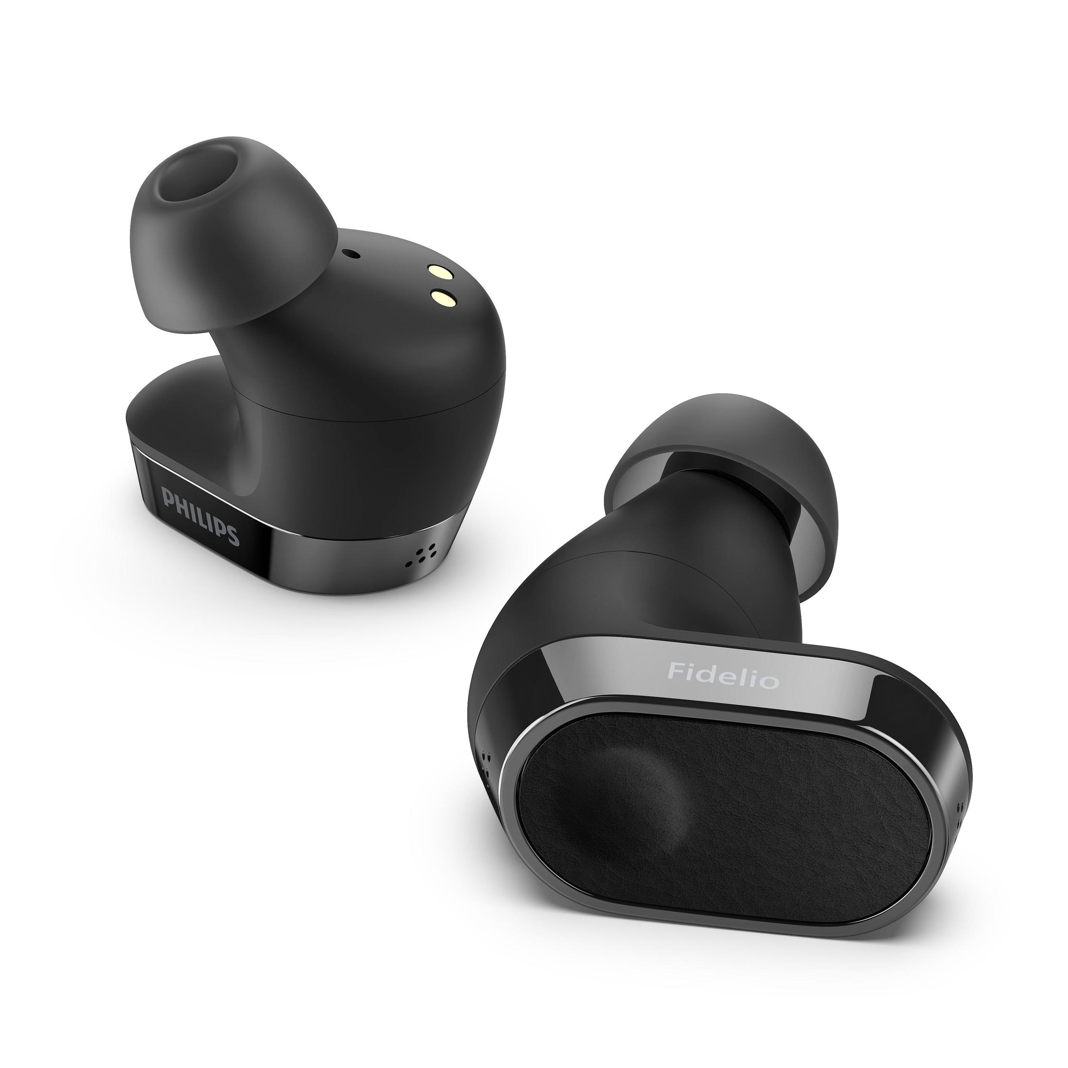 Dos auriculares inalámbricos Philips Fidelio negros. El izquierdo muestra el logo Philips, el derecho Fidelio.