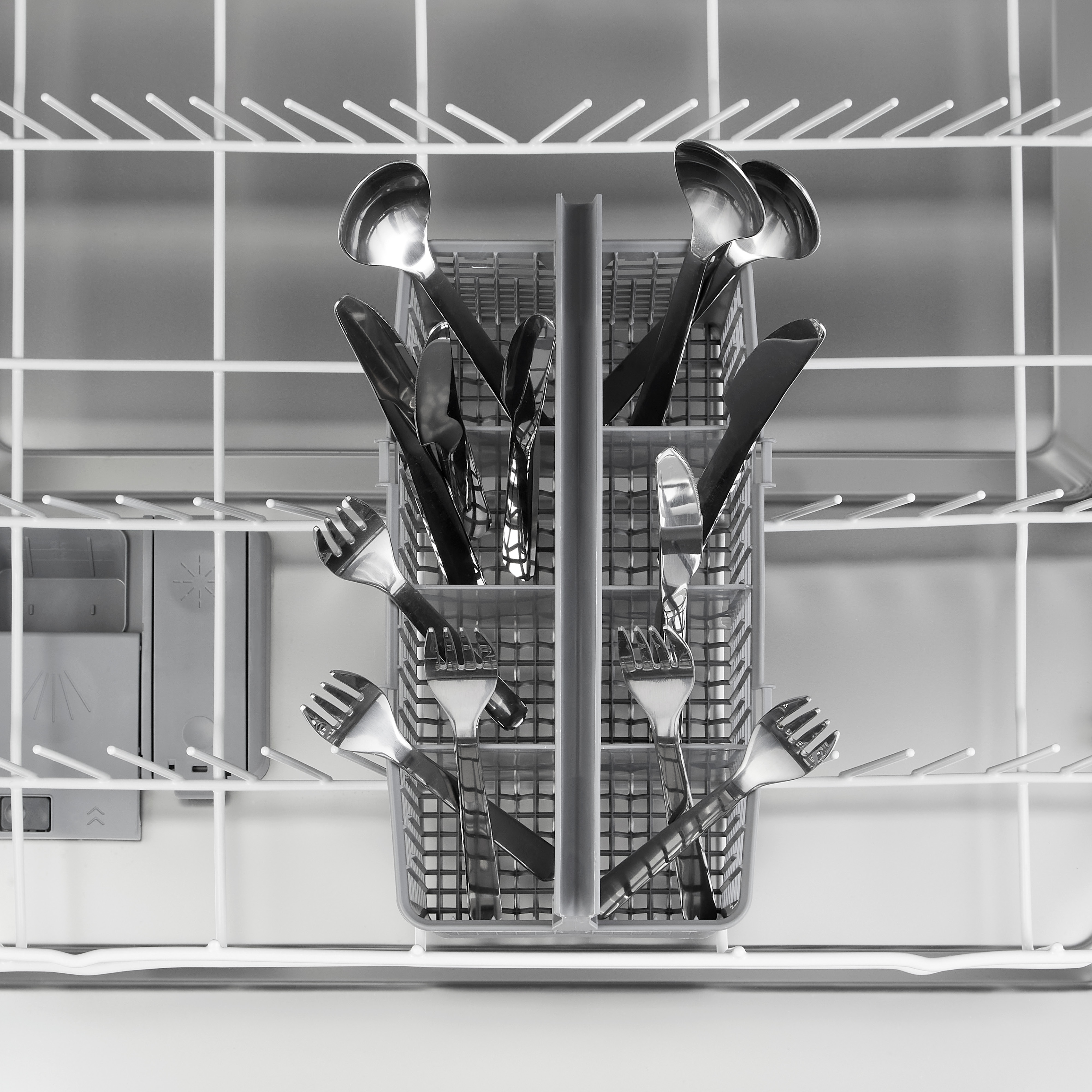Close-up of dishwasher's cutlery basket filled with forks and spoons. The basket is grey.