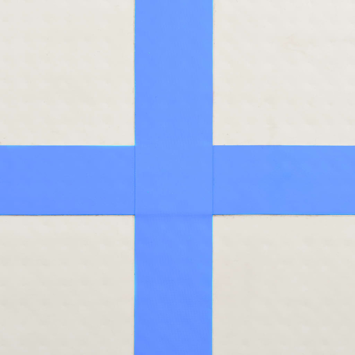 Nahaufnahme einer weißen Oberfläche mit einem blauen Kreuz. Die Kreuzform ist zentral.