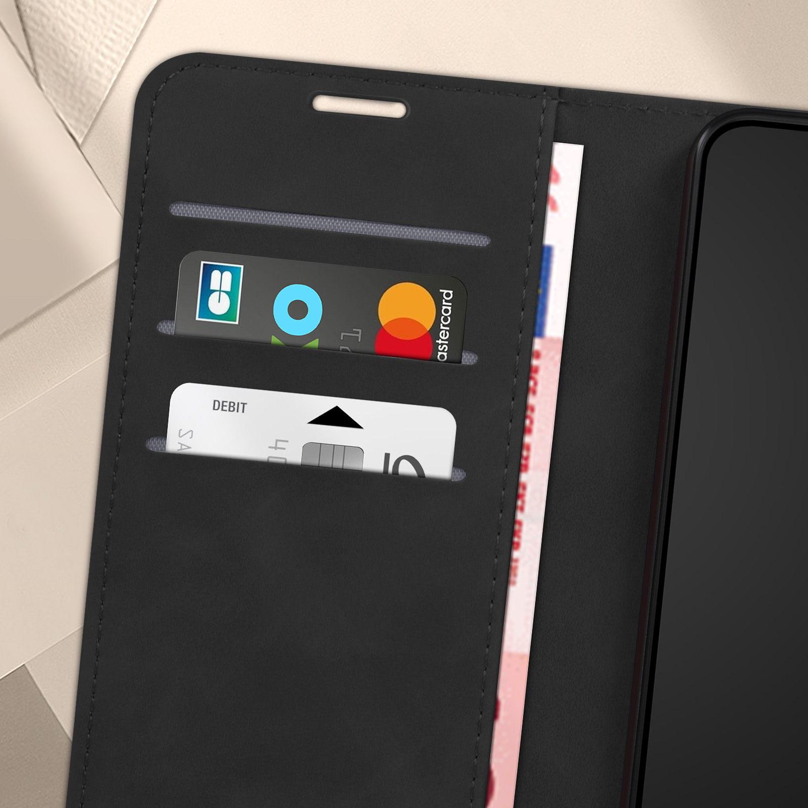 Custodia nera per telefono con carte all'interno. Carta di debito e Mastercard. Sfondo bianco.