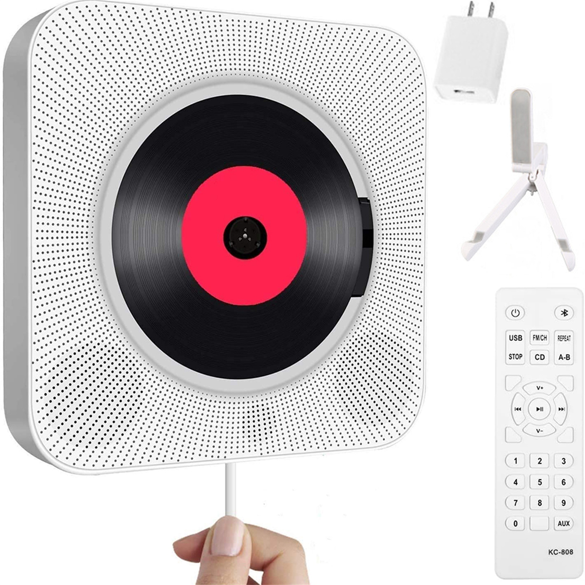 Weißer CD-Player mit roter Mitte, Fernbedienung, Netzteil und Ständer. Hand hält Kabel.