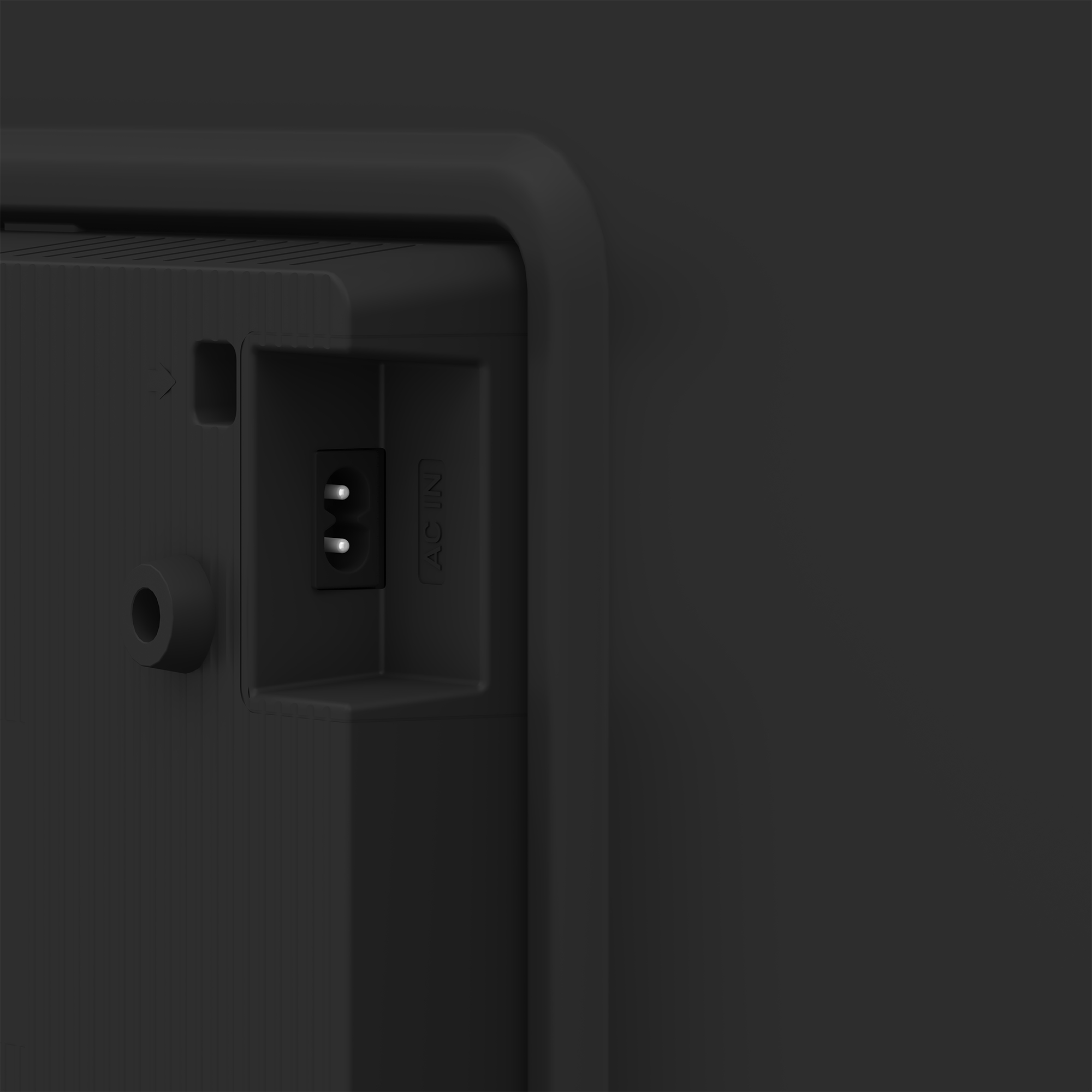 Zbliżenie tyłu czarnego monitora z portem AC IN i innymi punktami połączeń.