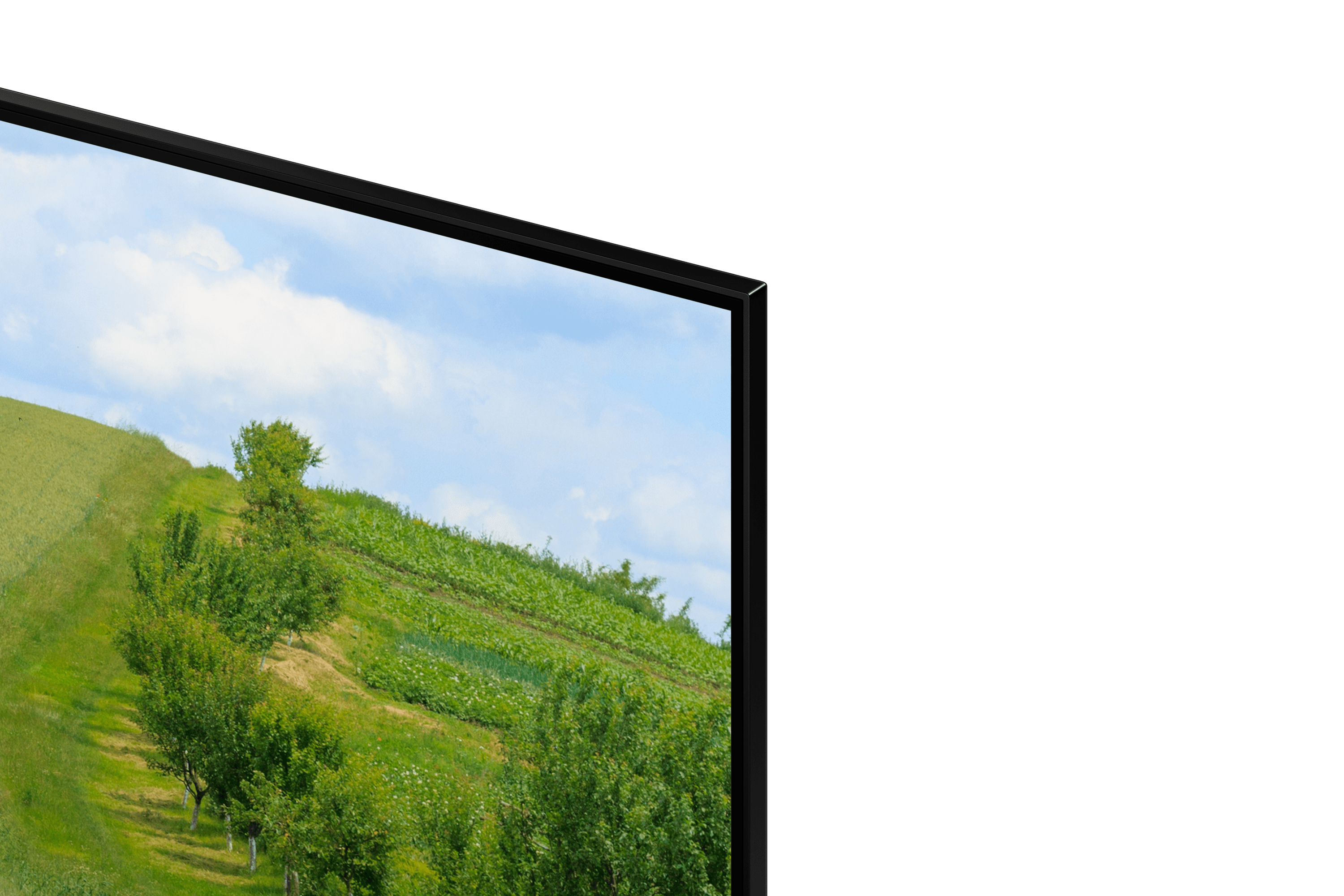 Zbliżenie telewizora pokazującego zielone wzgórze z drzewami i błękitnym niebem. Ramka jest czarna.