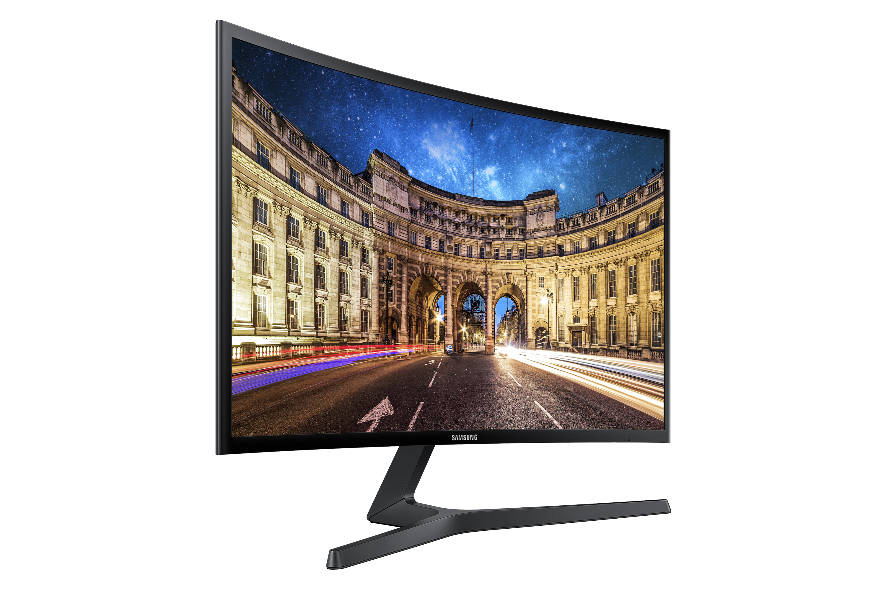 Monitor Samsung curvo che mostra una scena cittadina notturna, con edifici illuminati.
