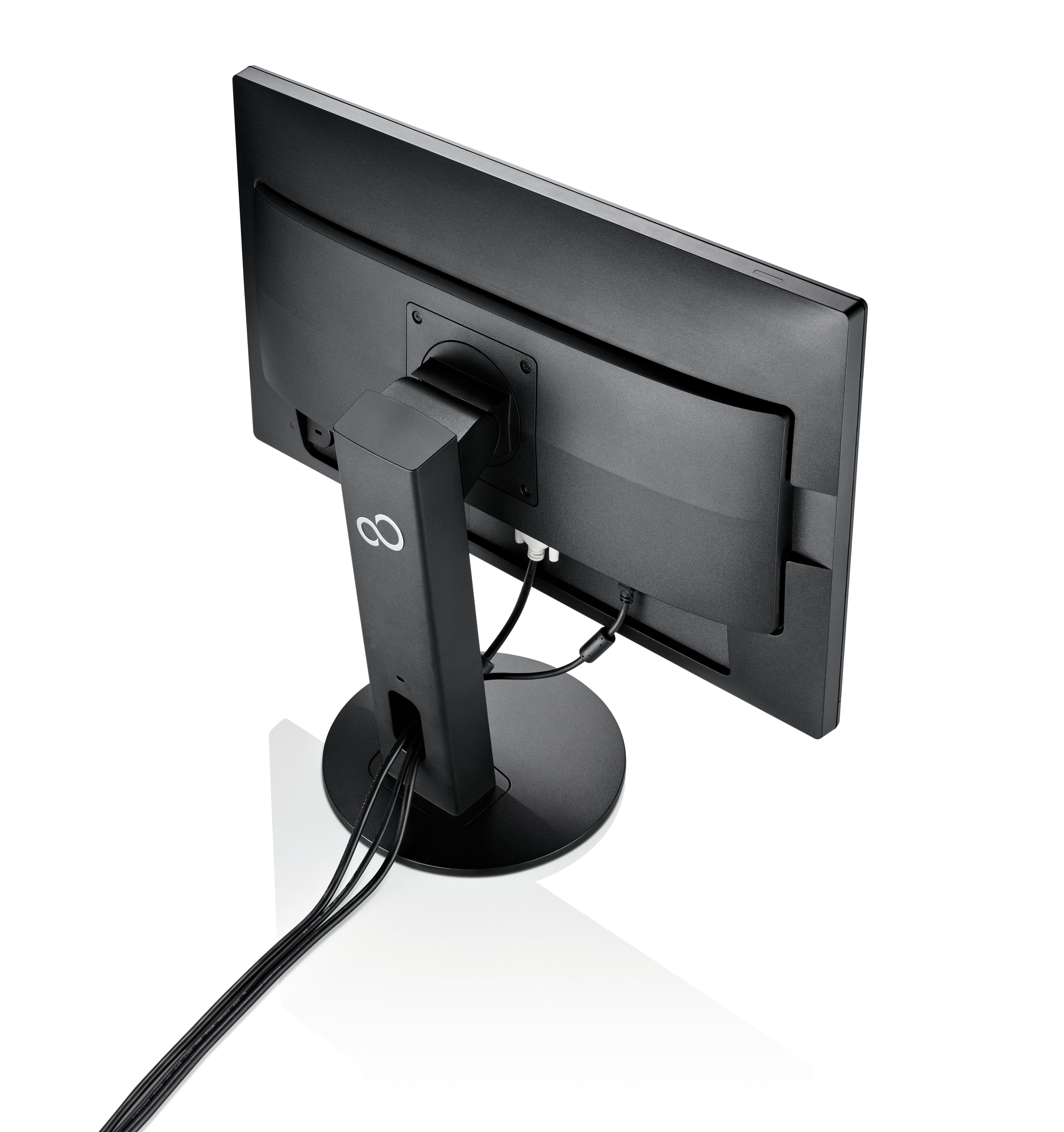 Un monitor de ordenador negro tiene un soporte redondeado y cables conectados. El monitor está inclinado.