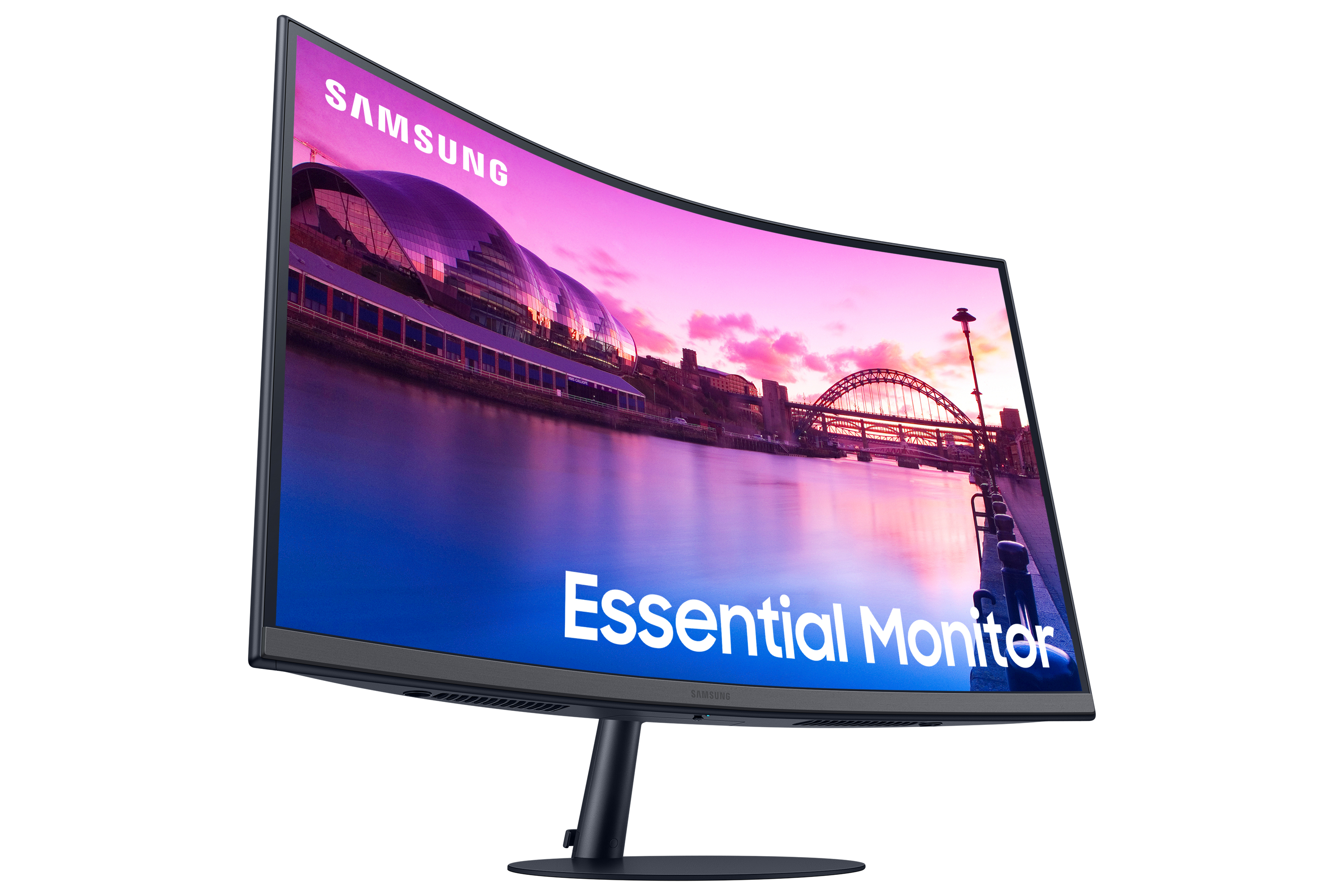 Zakrzywiony monitor Samsung z wyświetlonym miastem i zachodem słońca. Na ekranie widnieją słowa 'Essential Monitor'.
